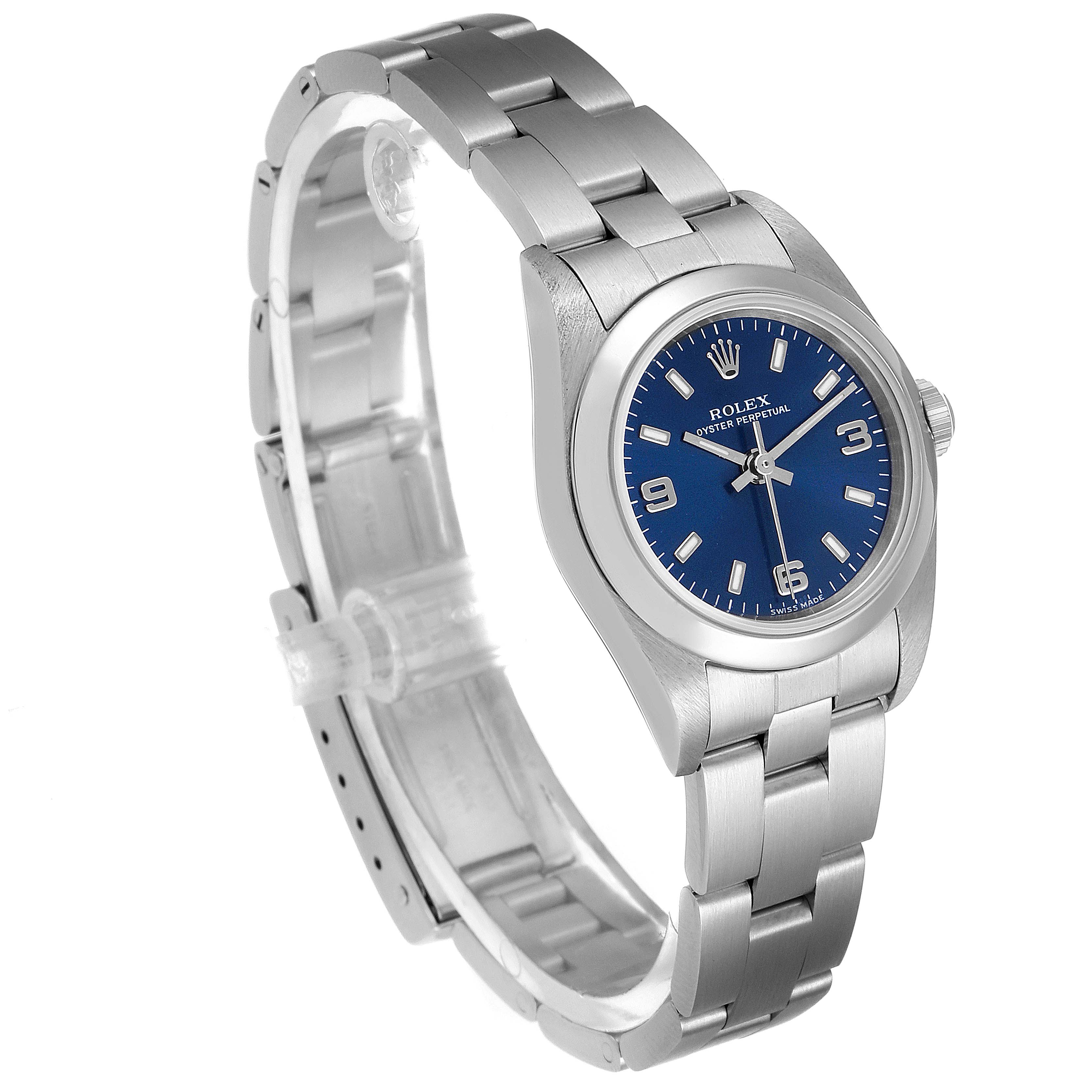 The image shows a Rolex Oyster Perpetual 76080 Women
s Stainless Steel Blue Dial 76080 Women
s Stainless Steel Blue Dial watch angled to display its bracelet, bezel, and blue dial.
