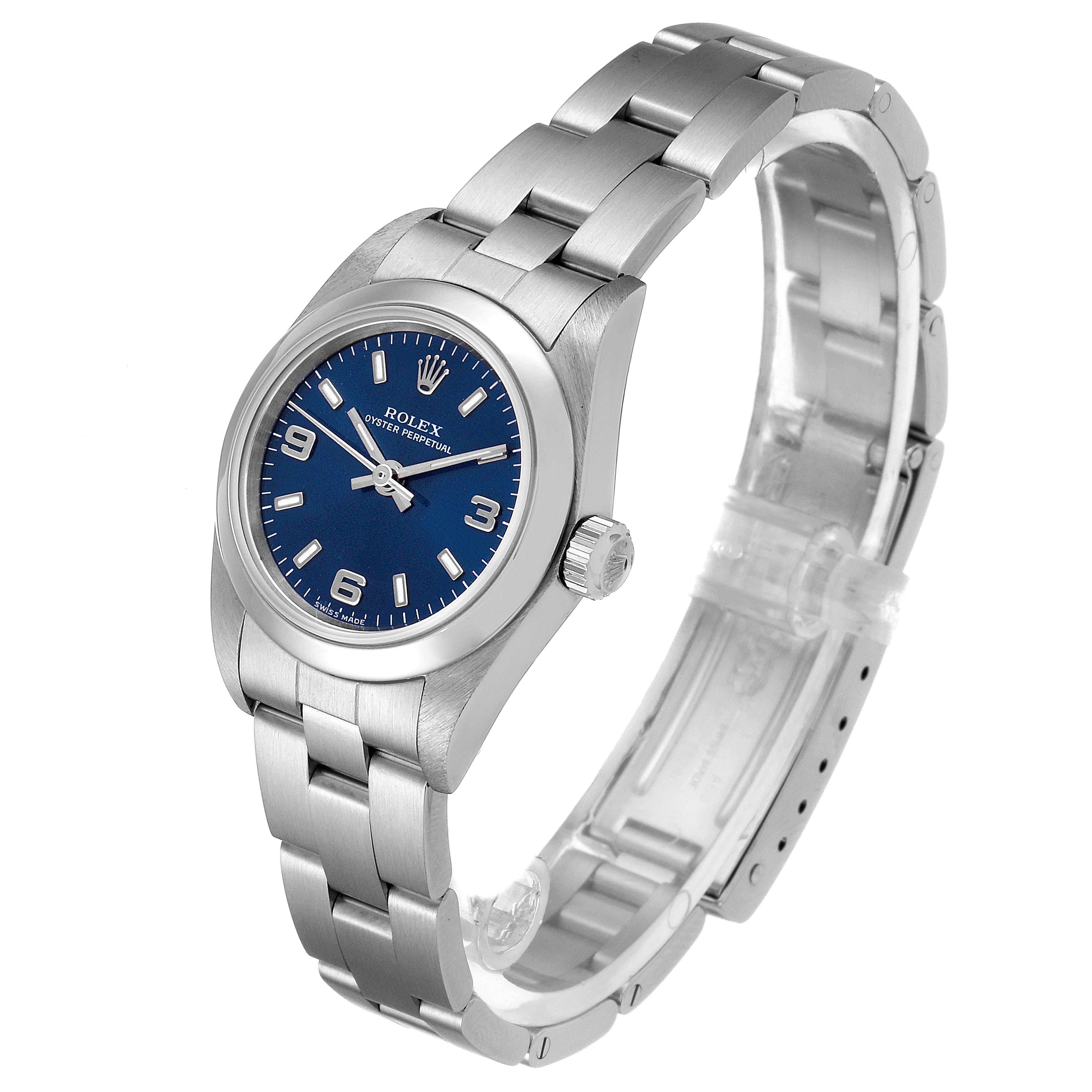 The Rolex Oyster Perpetual 76080 Women
s Stainless Steel Blue Dial 76080 Women
s Stainless Steel Blue Dial watch is shown at a side angle, displaying the face, crown, and bracelet.