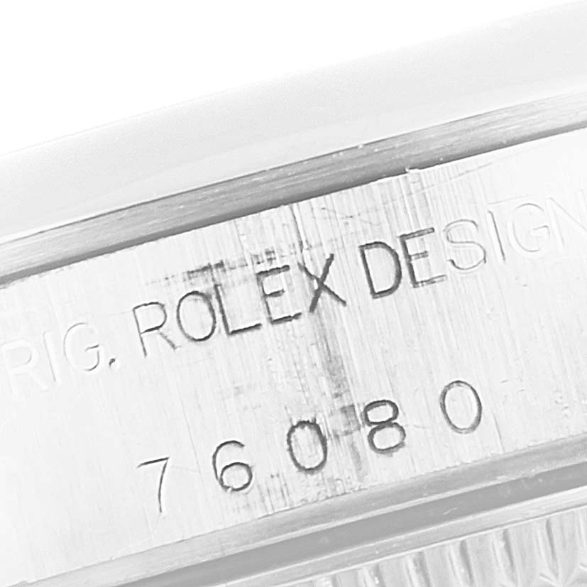 The image shows a close-up of the side case of a Rolex Oyster Perpetual 76080 Women
s Stainless Steel Blue Dial 76080 Women
s Stainless Steel Blue Dial watch, displaying the engraved model number and "Rolex Design" text.