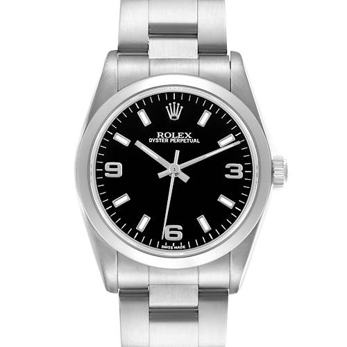 The Rolex Mid-Size watch is shown from a front angle, displaying its black dial, silver hands, numeric indices, and stainless steel bracelet.