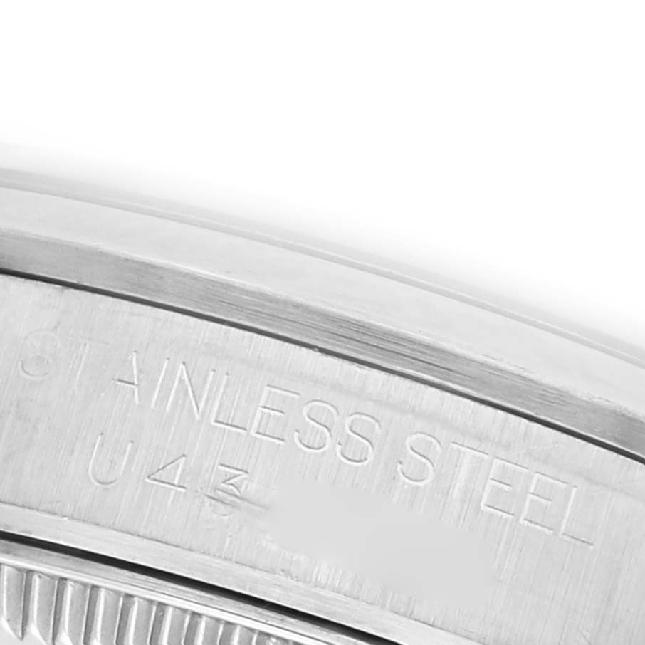 The image shows a close-up of the stainless steel back and engraving on a Rolex Mid-Size 67480 Women's Stainless Steel Black Dial 67480 Women's Stainless Steel Black Dial model watch.