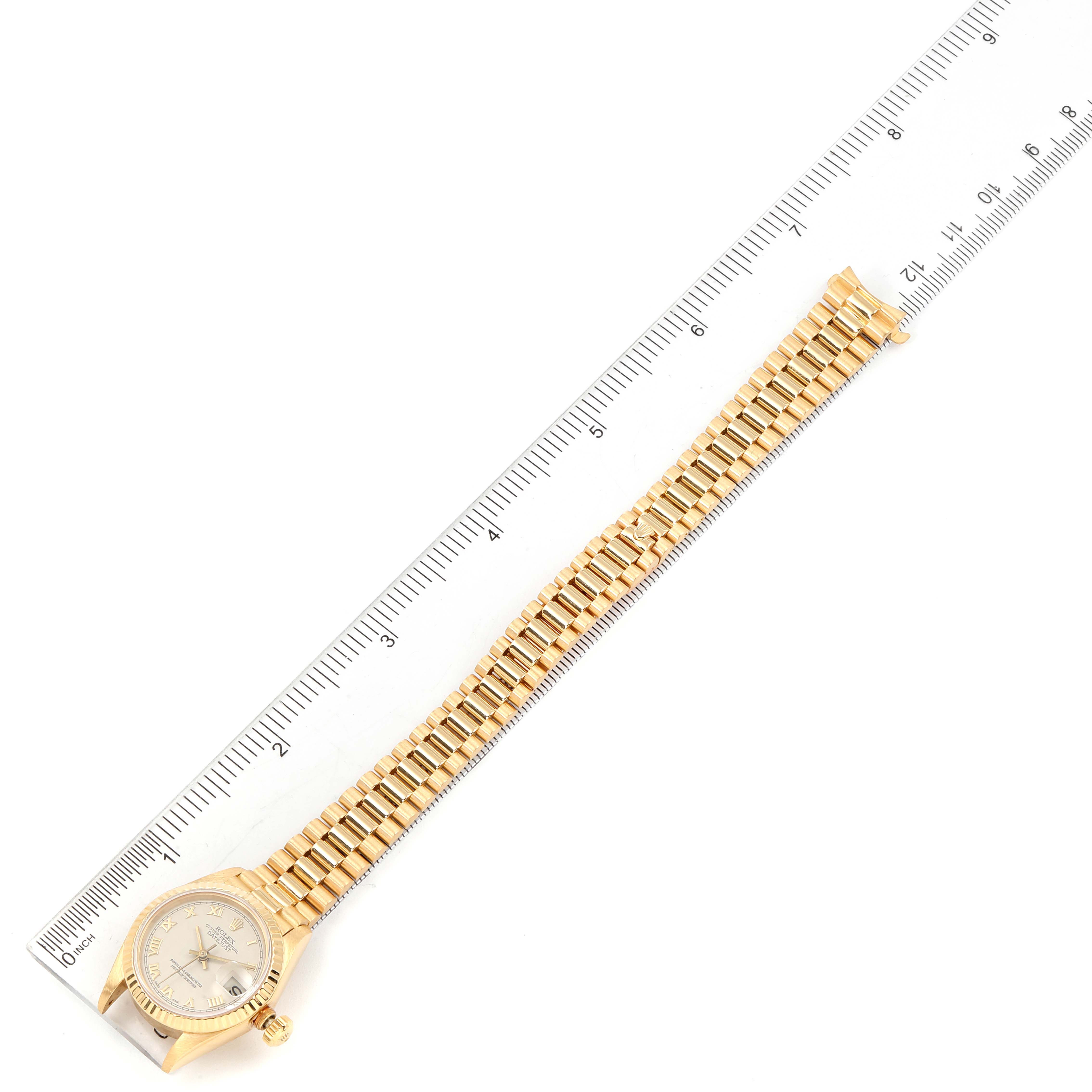 The image shows a top-down view of a Rolex President 69178 Women's Yellow Gold Beige Dial 69178 Women's Yellow Gold Beige Dial model watch placed alongside a ruler.