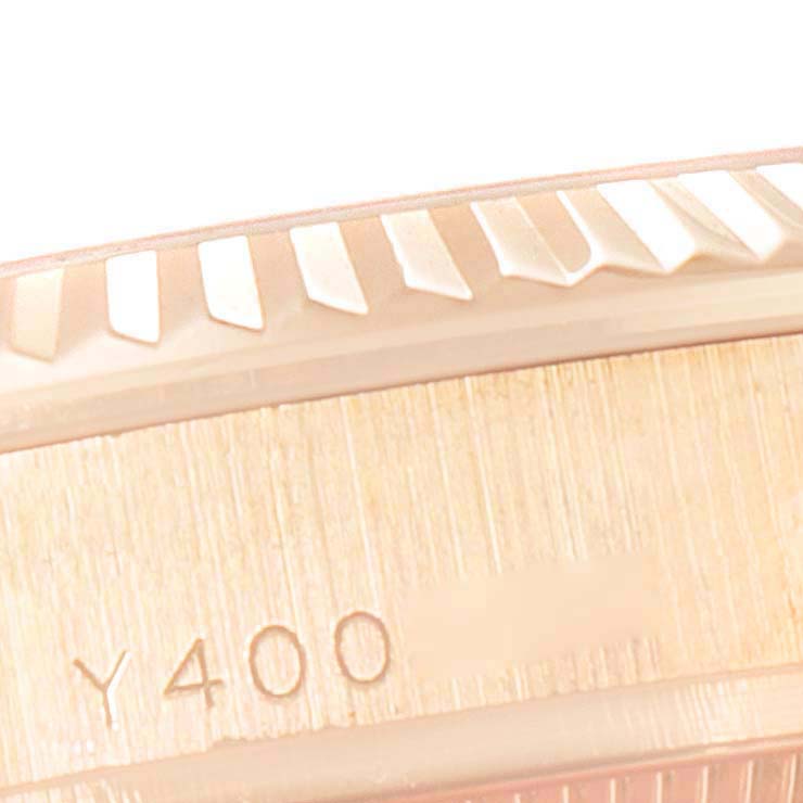 The image shows a close-up angle of the fluted bezel and part of the engraved serial number on a Rolex President 178275 Women's Rose Gold Silver Dial 178275 Women's Rose Gold Silver Dial model watch.