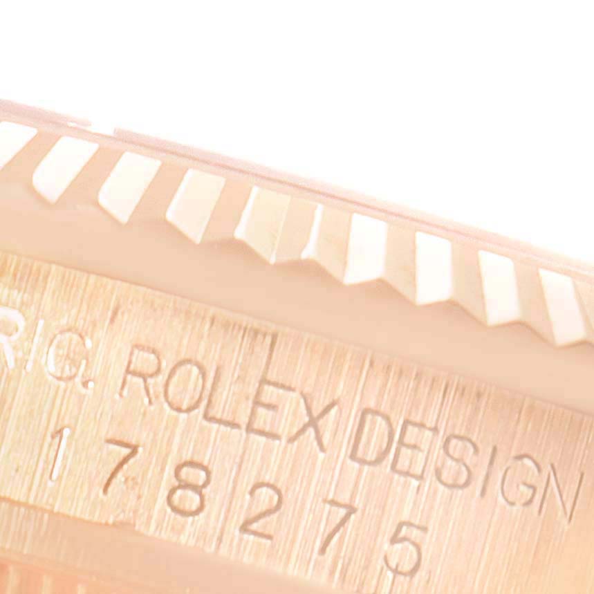 The image shows a close-up of the underside of the bezel and the engraved serial number on a Rolex President 178275 Women's Rose Gold Silver Dial 178275 Women's Rose Gold Silver Dial model watch.