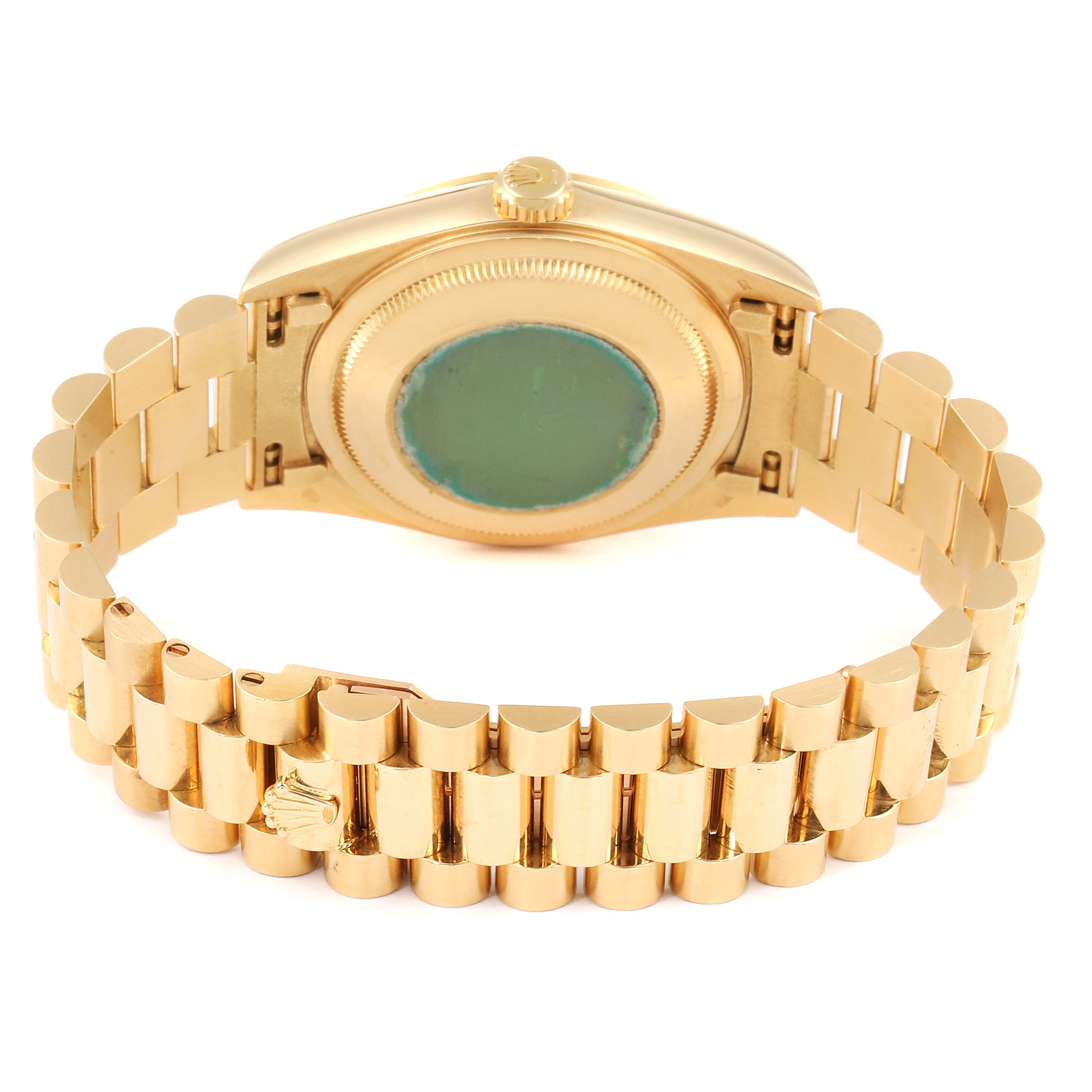 The image shows the back view of a President model Rolex watch, highlighting its gold bracelet and case back.