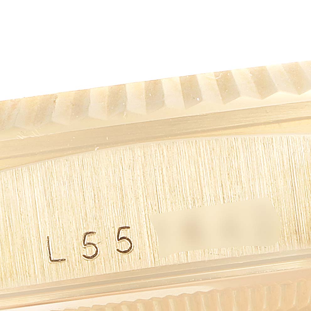 This close-up image shows the serial number engraving on the case of a Rolex President 18238 Men's Yellow Gold Champagne Dial 18238 Men's Yellow Gold Champagne Dial model watch.