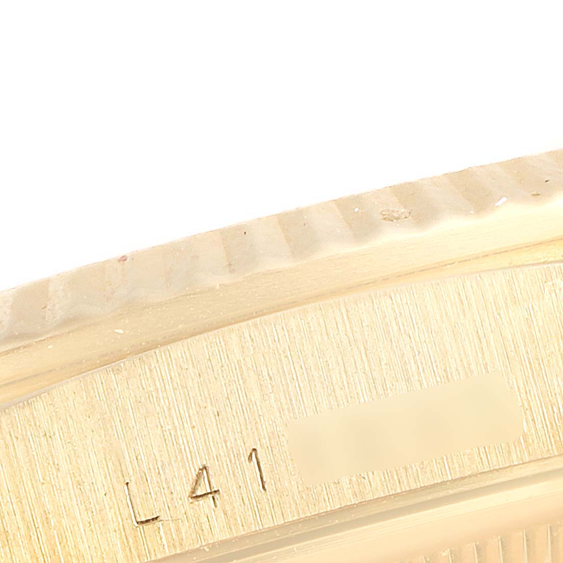 The image shows a close-up angle of the model and serial number engraving on a Rolex President 18238 Men
s Yellow Gold Champagne Dial 18238 Men
s Yellow Gold Champagne Dial watch
s case.