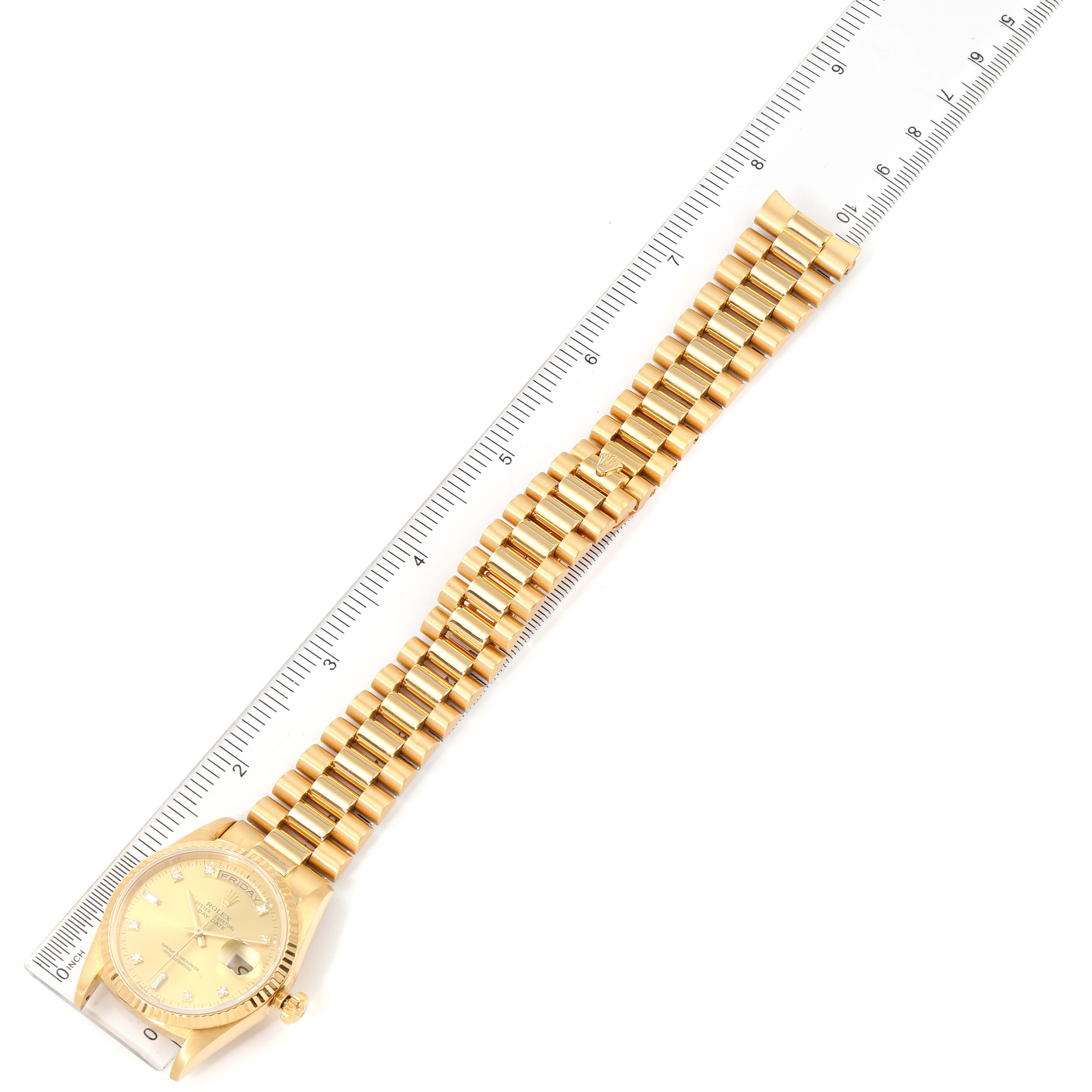 The image shows a Rolex President 18238 Men
s Yellow Gold Champagne Dial 18238 Men
s Yellow Gold Champagne Dial model watch laid flat with a ruler beside it.