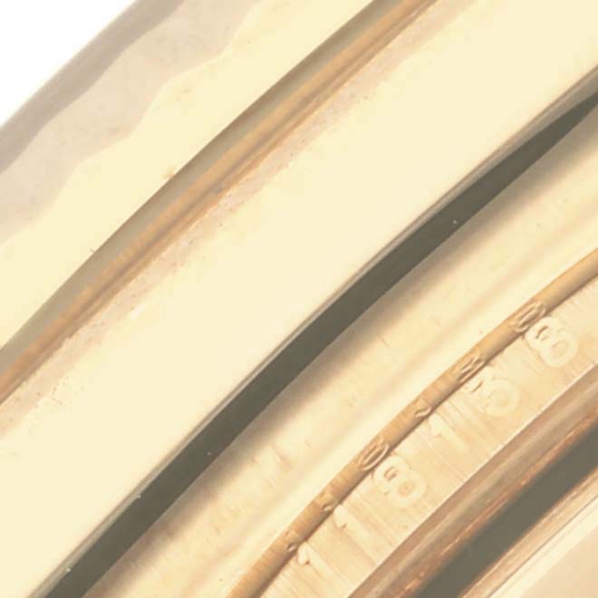 The image shows a close-up of the gold fluted bezel and part of the dial of a Rolex President 118138 Men's Yellow Gold Green Dial 118138 Men's Yellow Gold Green Dial model watch.