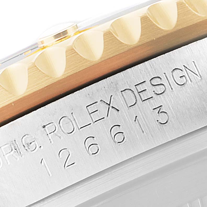 The image shows a close-up of the casing and bezel edge of a Rolex Submariner 126613 Men's Steel and Gold (two tone) Black Dial 126613 Men's Steel and Gold (two tone) Black Dial, with engraved markings visible.