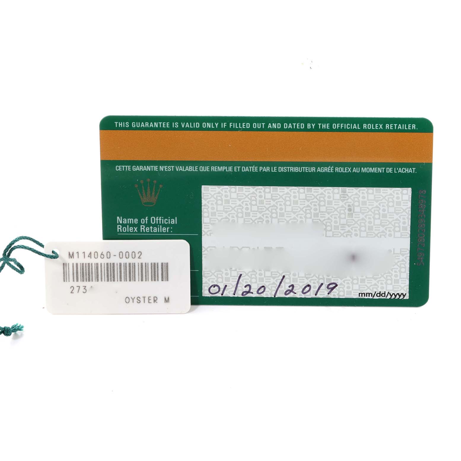 The image shows the warranty card and tag for a Rolex Submariner 114060 Men
s Stainless Steel Black Dial 114060 Men
s Stainless Steel Black Dial watch.