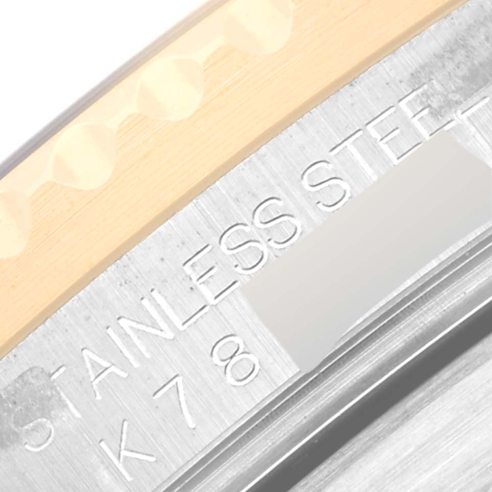 This is a close-up of the Rolex Submariner 16613 Men's Steel and Gold (two tone) Blue Dial 16613 Men's Steel and Gold (two tone) Blue Dial's case back, showcasing the "STAINLESS STEEL" engraving and part of the bezel.