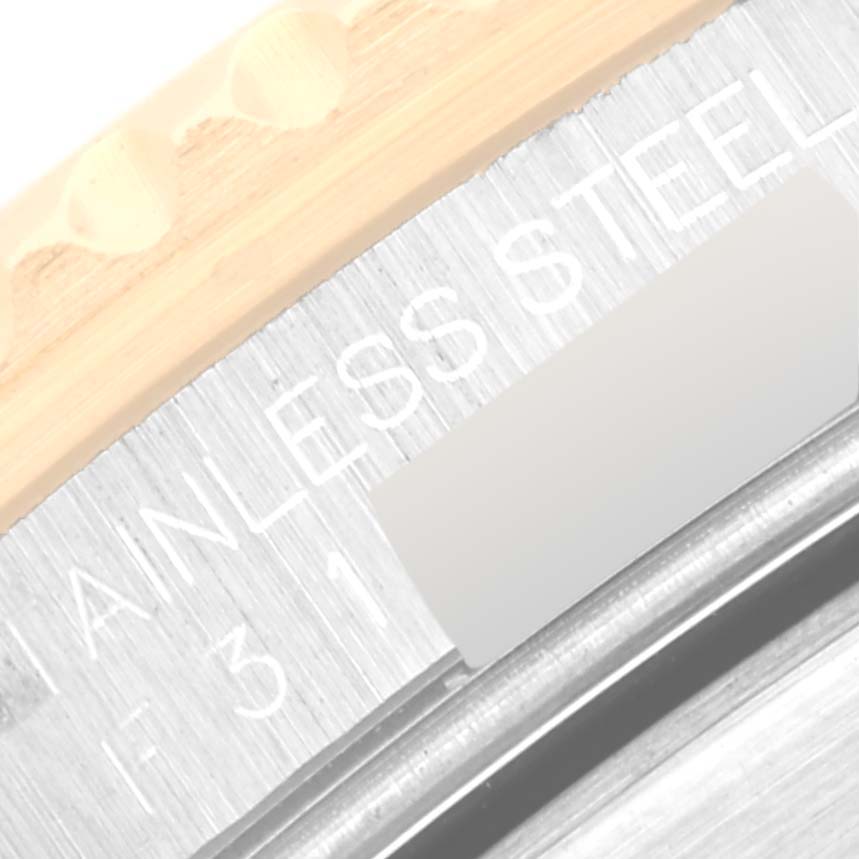 The image shows a close-up of the stainless steel part and bezel edge of a Rolex Submariner 16613T Men
s Steel and Gold (two tone) Blue Dial 16613T Men
s Steel and Gold (two tone) Blue Dial watch.