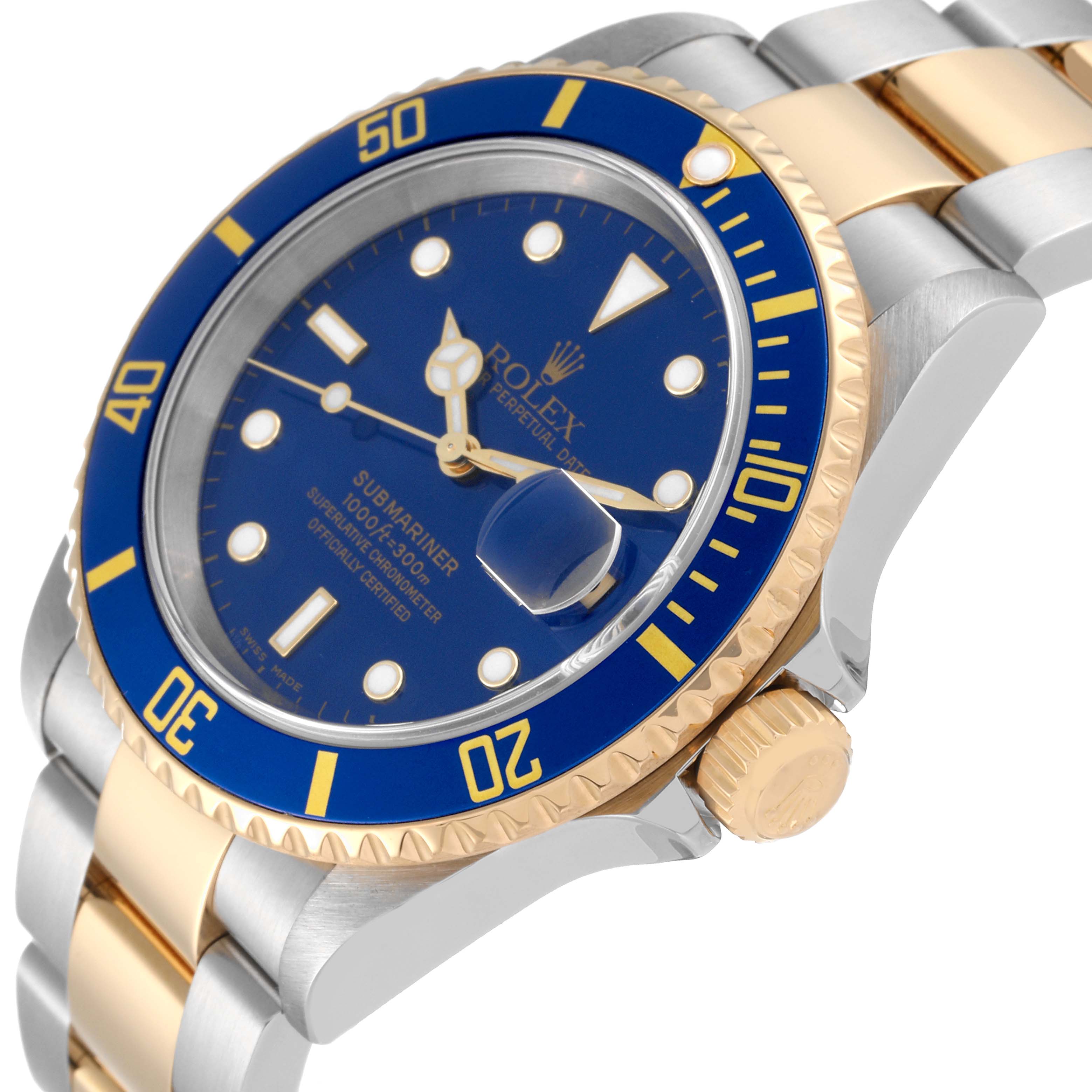 This Rolex Submariner 16613T Men
s Steel and Gold (two tone) Blue Dial 16613T Men
s Steel and Gold (two tone) Blue Dial watch is shown at an oblique angle, highlighting its blue dial, bezel, two-tone band, and crown.