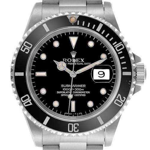 The Rolex Submariner watch is shown from a frontal angle, displaying the dial, bezel, and part of the bracelet.