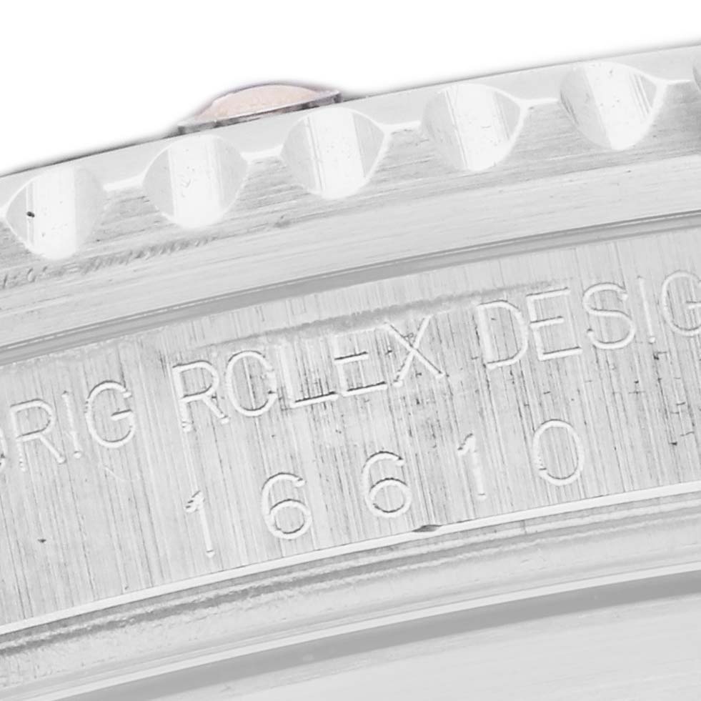 The image shows a close-up of the bezel and engraved serial number on a Rolex Submariner 16610 Men's Stainless Steel Black Dial 16610 Men's Stainless Steel Black Dial watch.