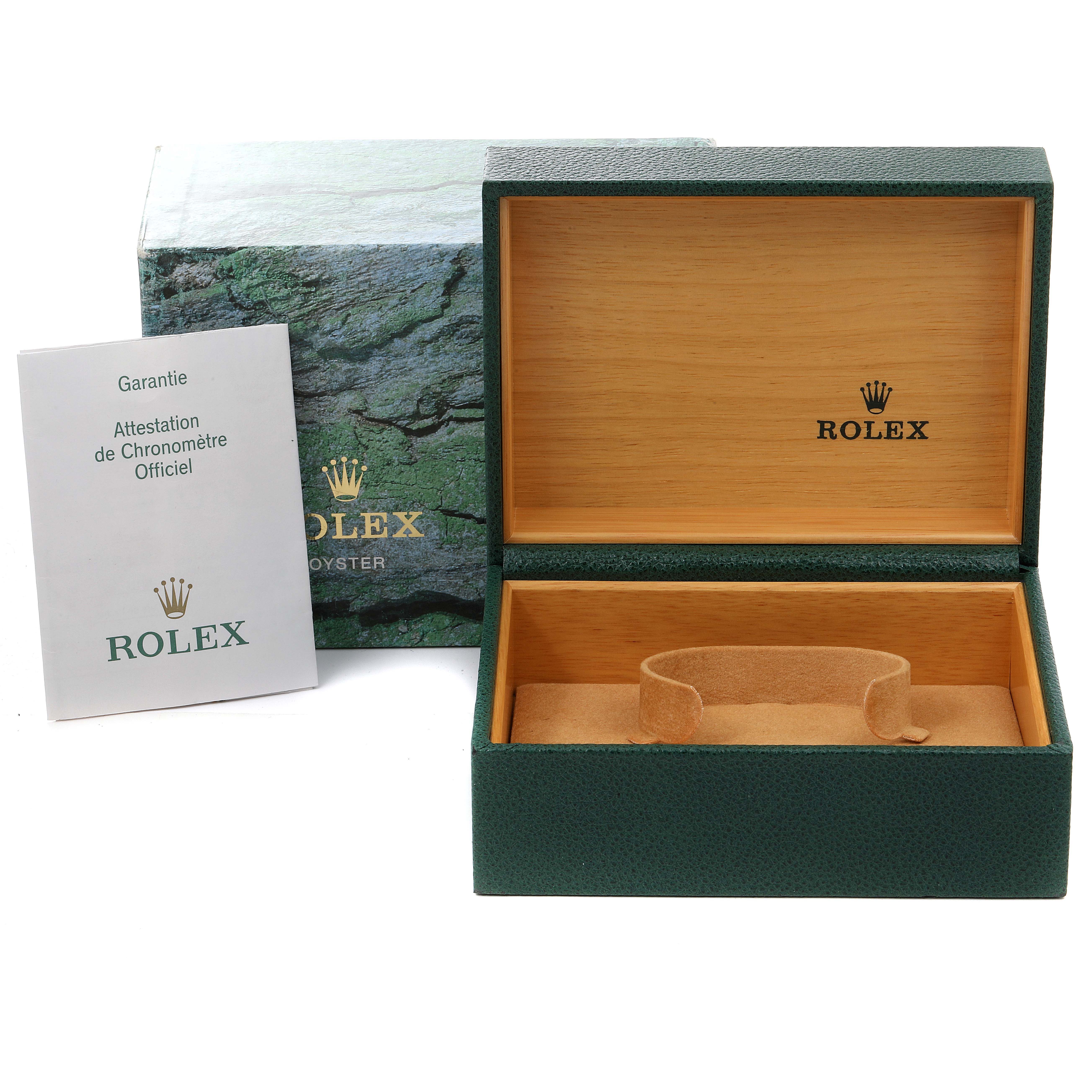 The image shows a green Rolex box with the interior open, alongside the official warranty booklet for the Submariner model.