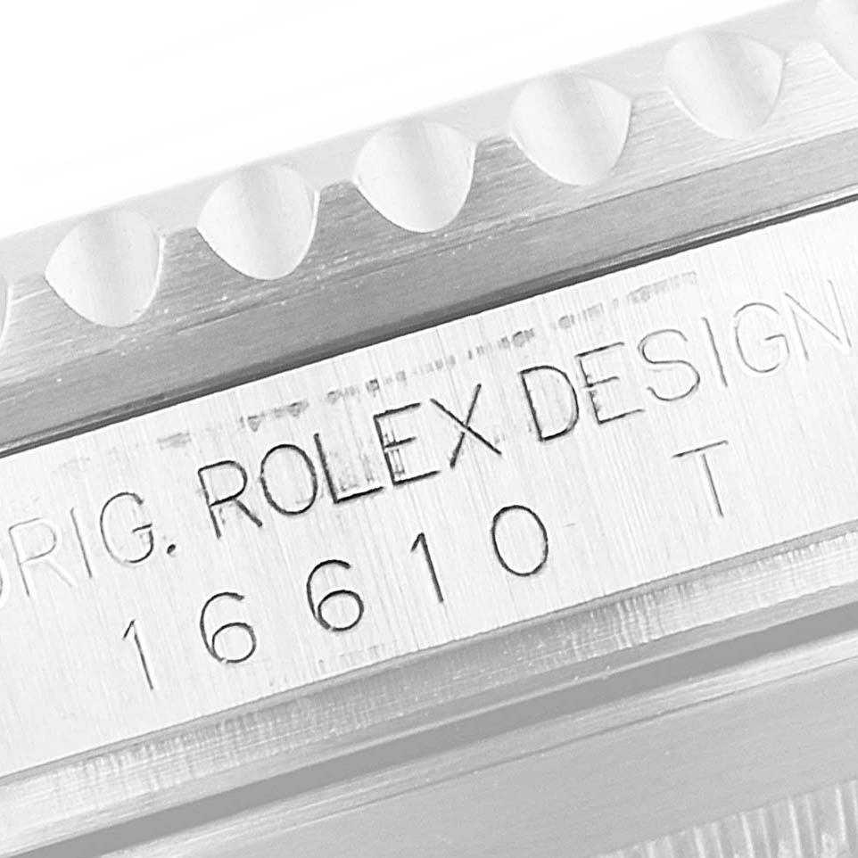 The image shows a close-up of the engraved side of the Rolex Submariner 16610LV Men
s Stainless Steel Black Dial 16610LV Men
s Stainless Steel Black Dial model 16610.