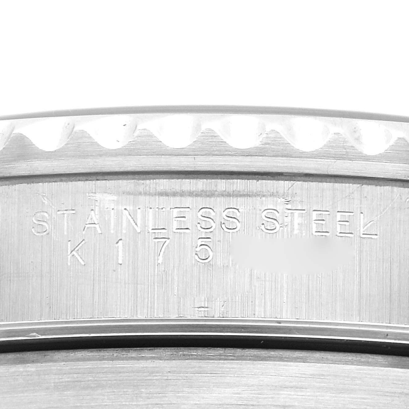 This image shows a close-up of a stainless steel marking and serial number on the bezel of a Rolex Submariner 14060 Men
s Stainless Steel Black Dial 14060 Men
s Stainless Steel Black Dial watch.