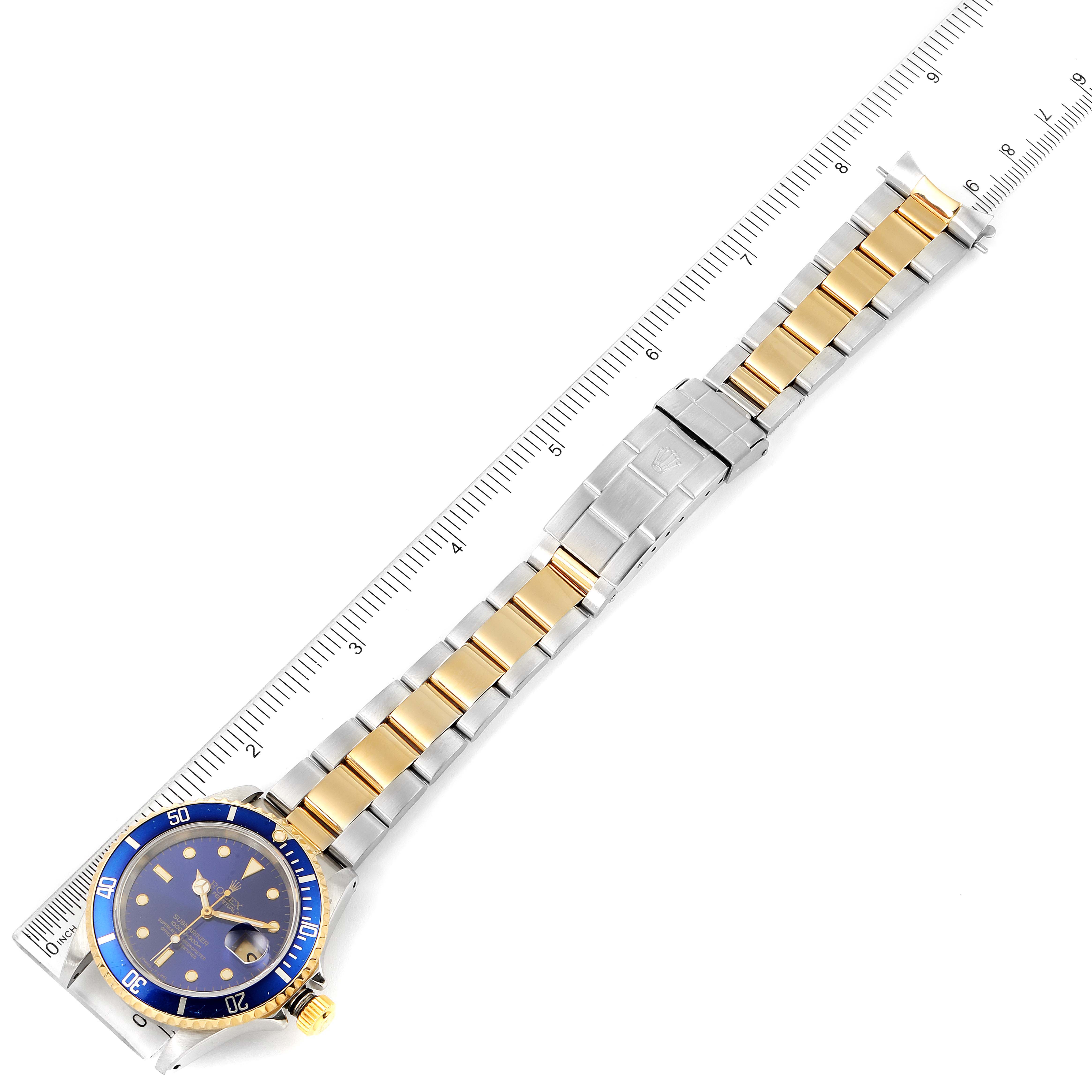 The image shows a top-down view of a Rolex Submariner 16613 Men
s Steel and Gold (two tone) Blue Dial 16613 Men
s Steel and Gold (two tone) Blue Dial watch, featuring its face, bezel, and two-tone bracelet measured with a ruler.