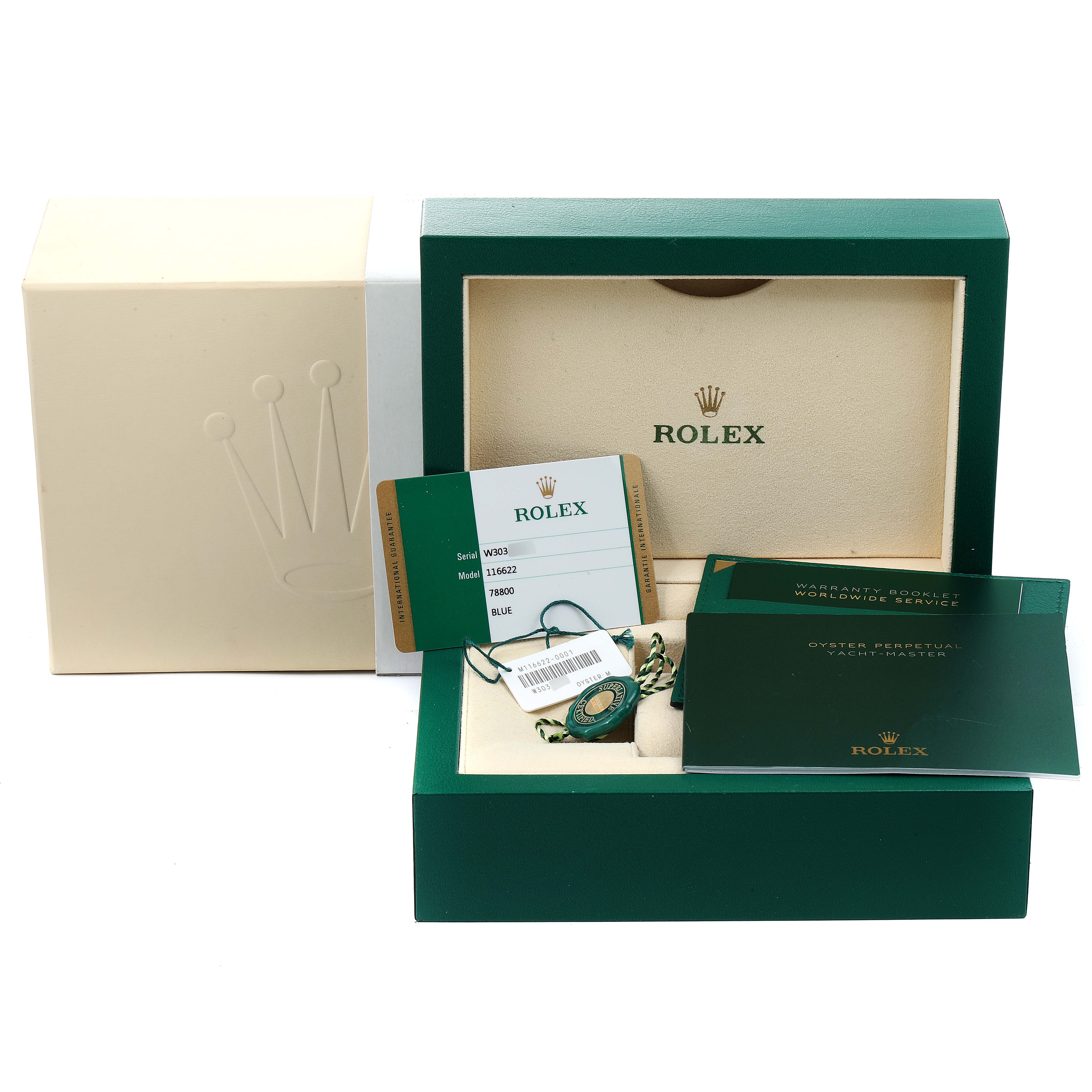 The image shows the packaging, warranty card, and booklets for a Rolex Yacht-Master 116622 Men
s Stainless Steel Blue Dial 116622 Men
s Stainless Steel Blue Dial watch at an angled view.
