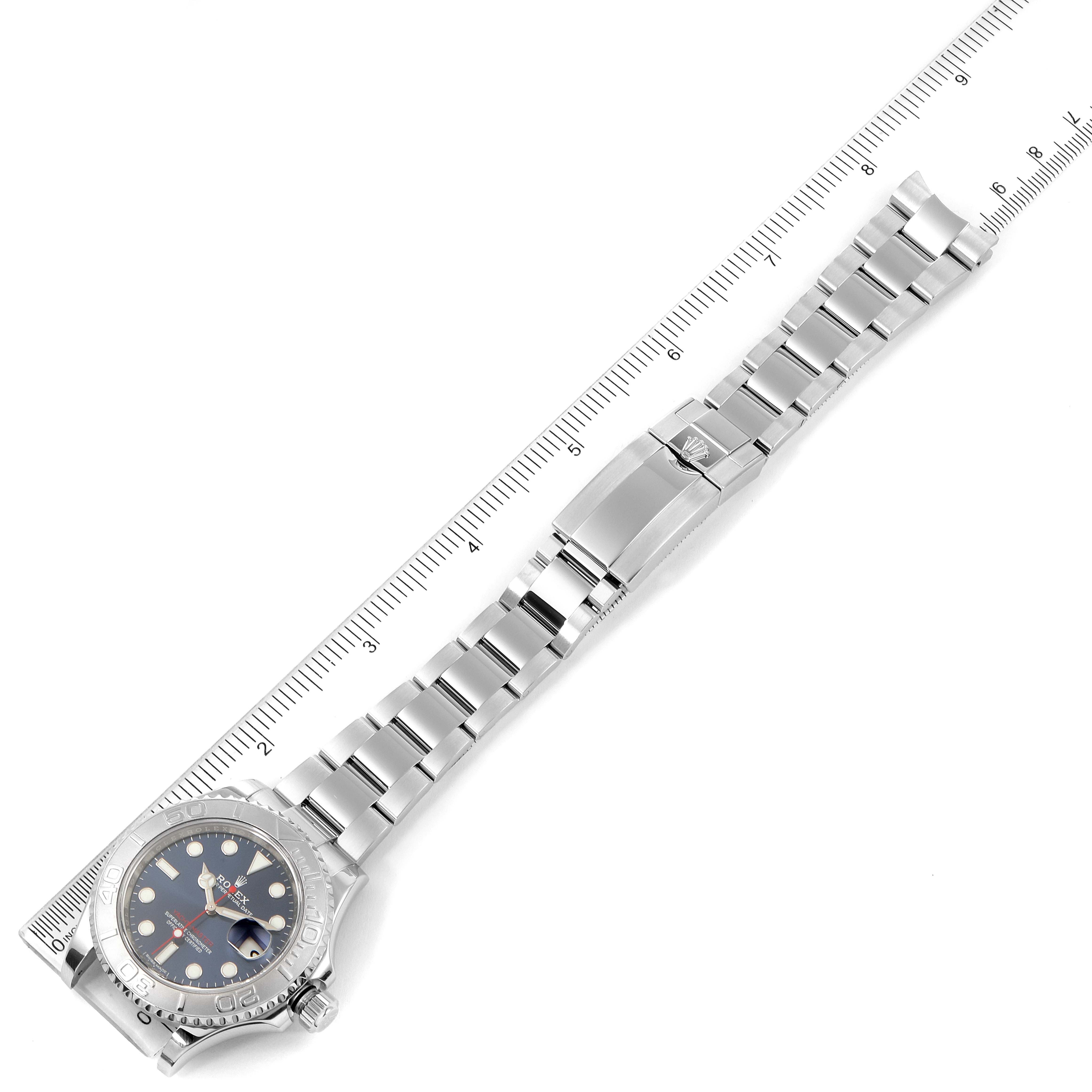 The Rolex Yacht-Master 116622 Men
s Stainless Steel Blue Dial 116622 Men
s Stainless Steel Blue Dial watch is shown from a top view with its full bracelet and clasp exposed alongside a ruler.