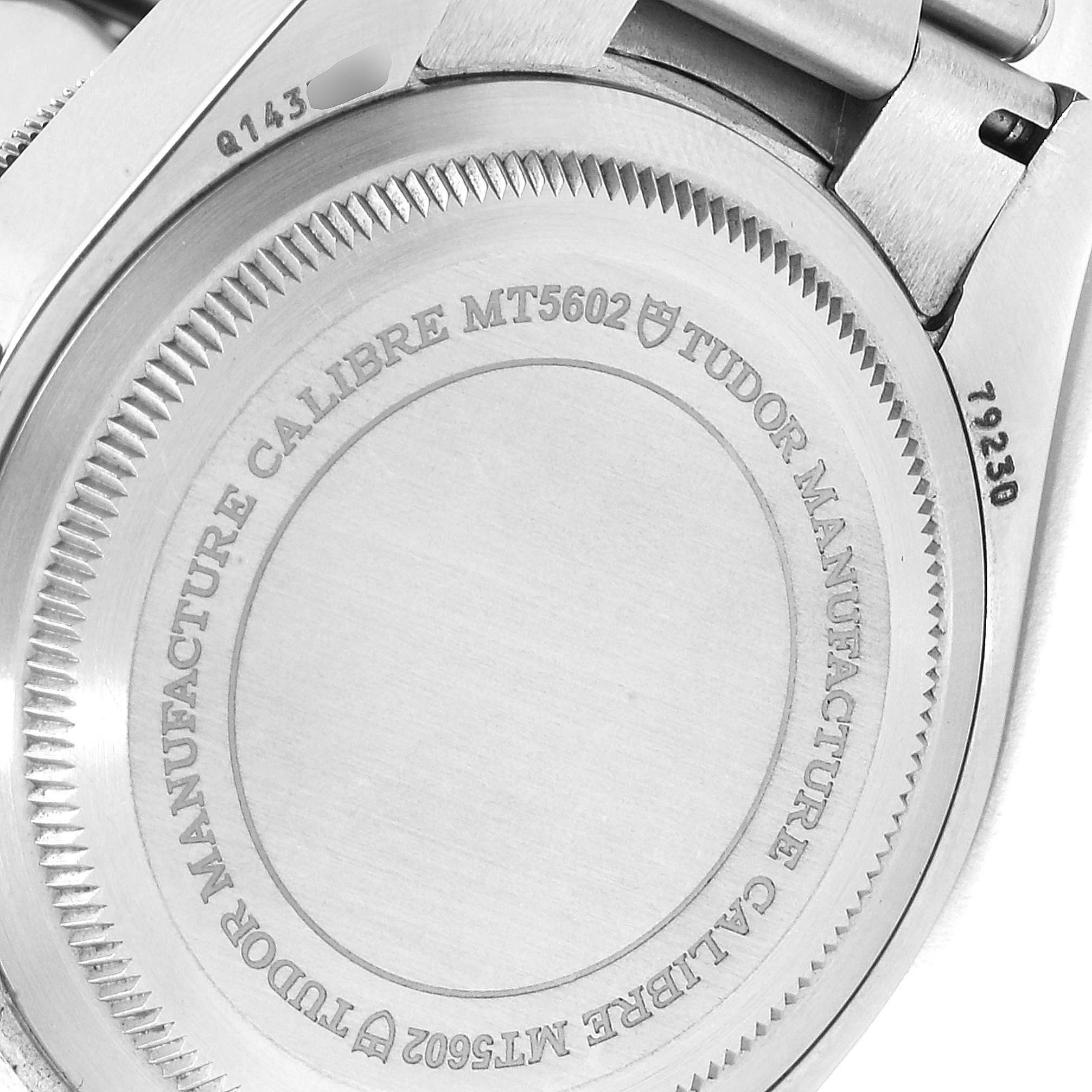 The image shows the back case of a Tudor Heritage Black Bay 79230B Men's Stainless Steel Black Dial 79230B Men's Stainless Steel Black Dial watch, highlighting the engraving and model number.