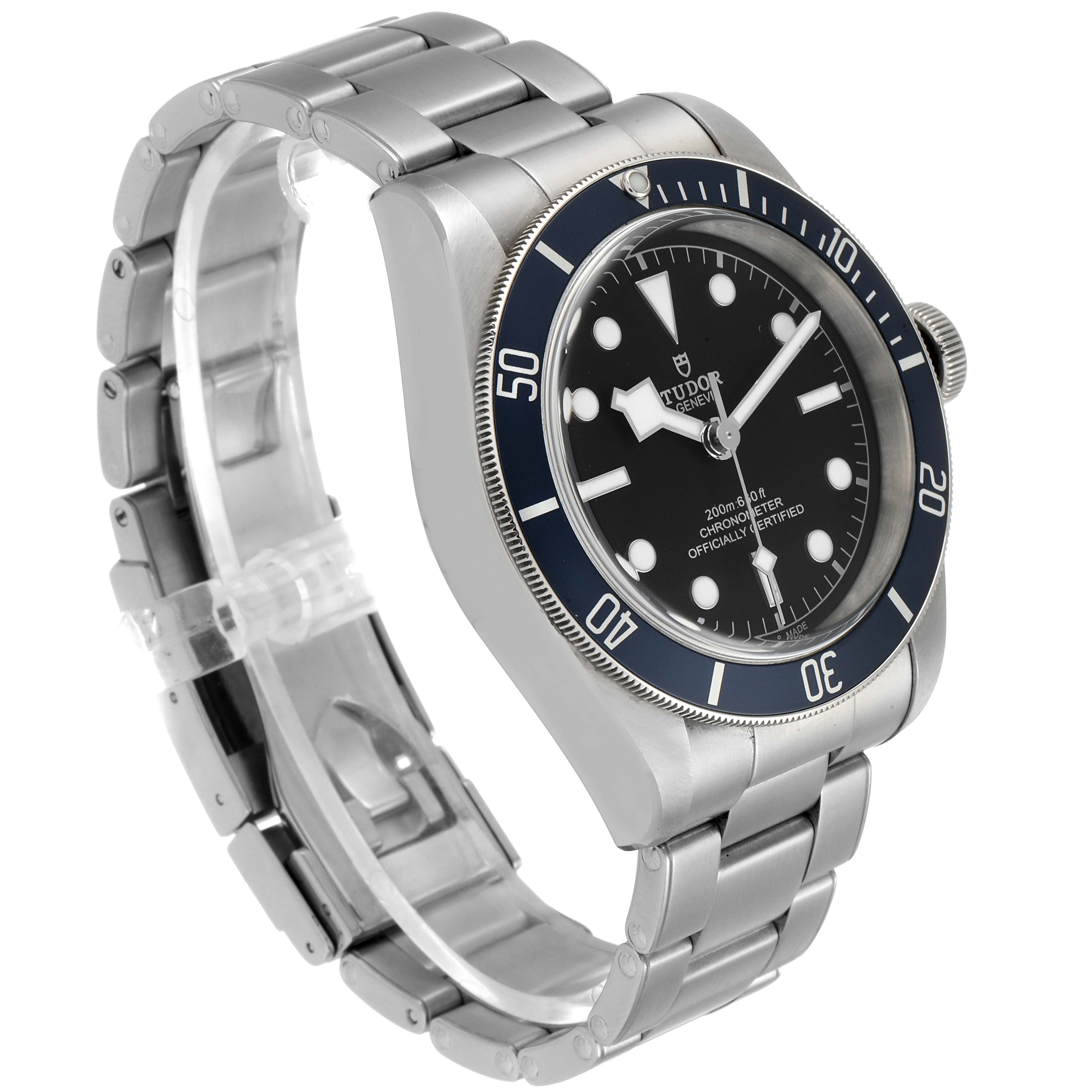 The Tudor Heritage Black Bay 79230B Men's Stainless Steel Black Dial 79230B Men's Stainless Steel Black Dial watch is shown at an angle, displaying its face, bezel, crown, and stainless steel bracelet.