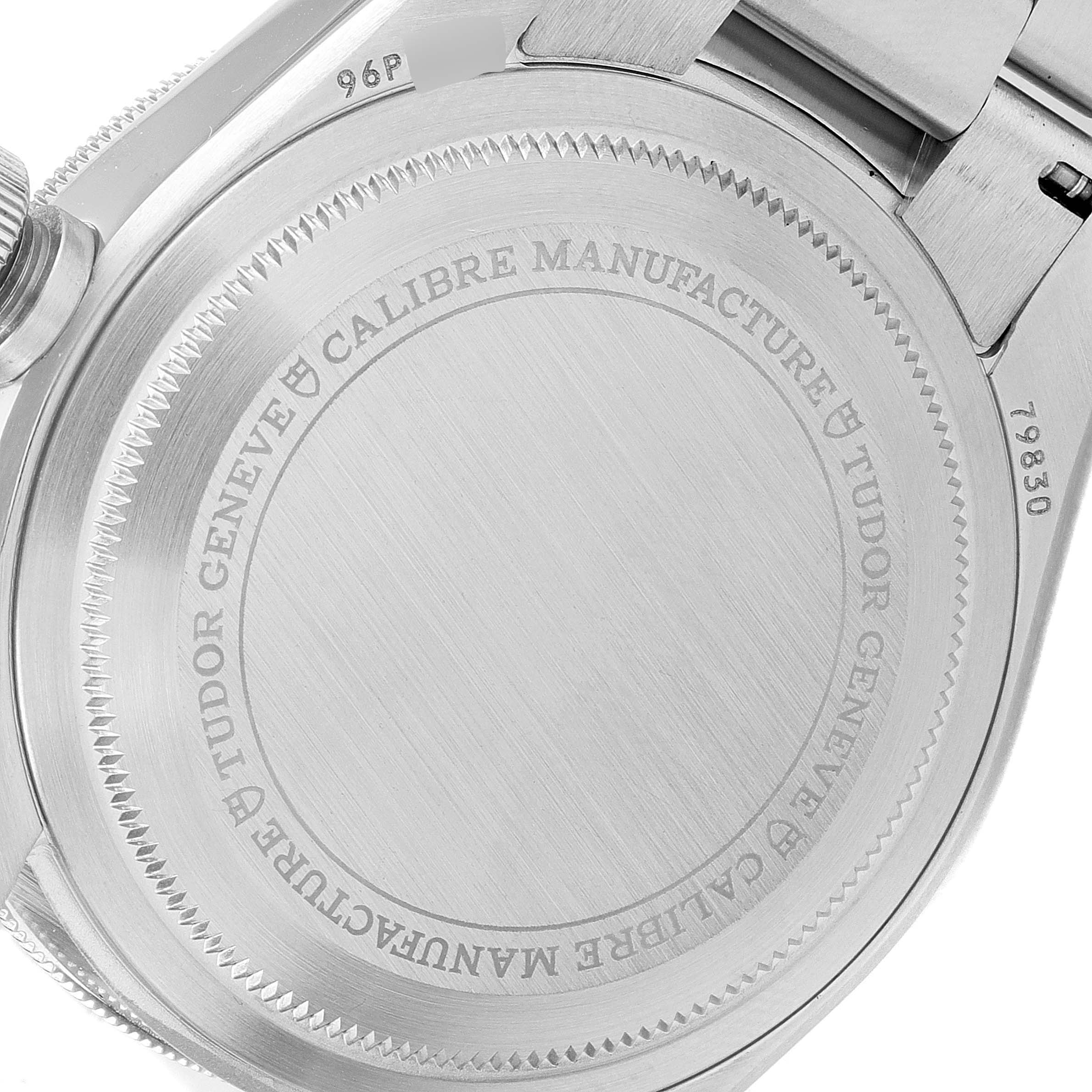 This image shows the back case of the Tudor Heritage Black Bay 79830RB Men's Stainless Steel Black Dial 79830RB Men's Stainless Steel Black Dial watch, viewed from a close-up angle displaying the inscriptions.