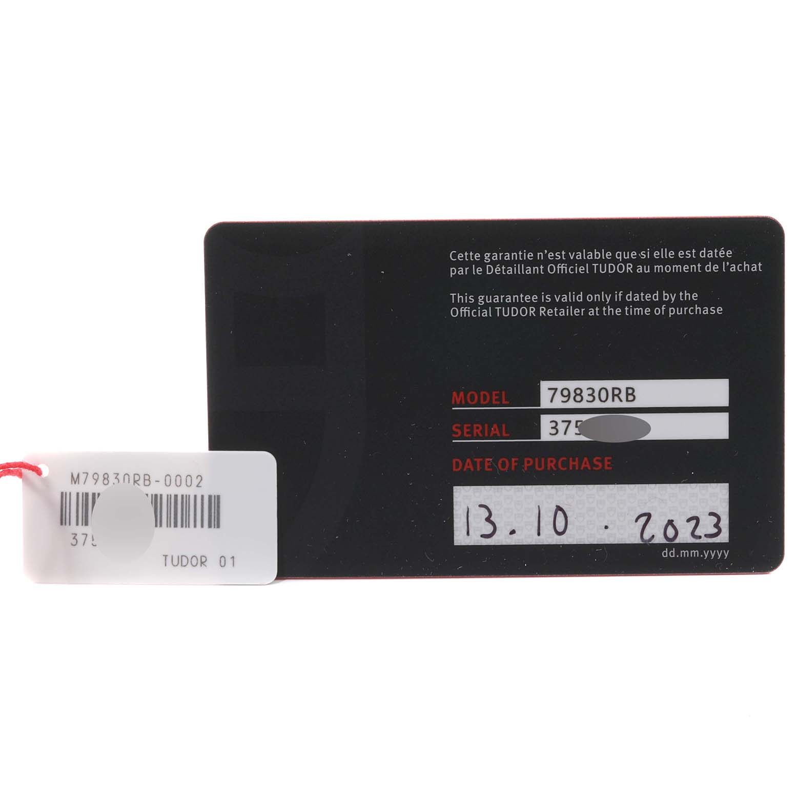 This image shows the warranty card and tag for the Tudor Heritage Black Bay 79830RB Men
s Stainless Steel Black Dial 79830RB Men
s Stainless Steel Black Dial model 79830RB.