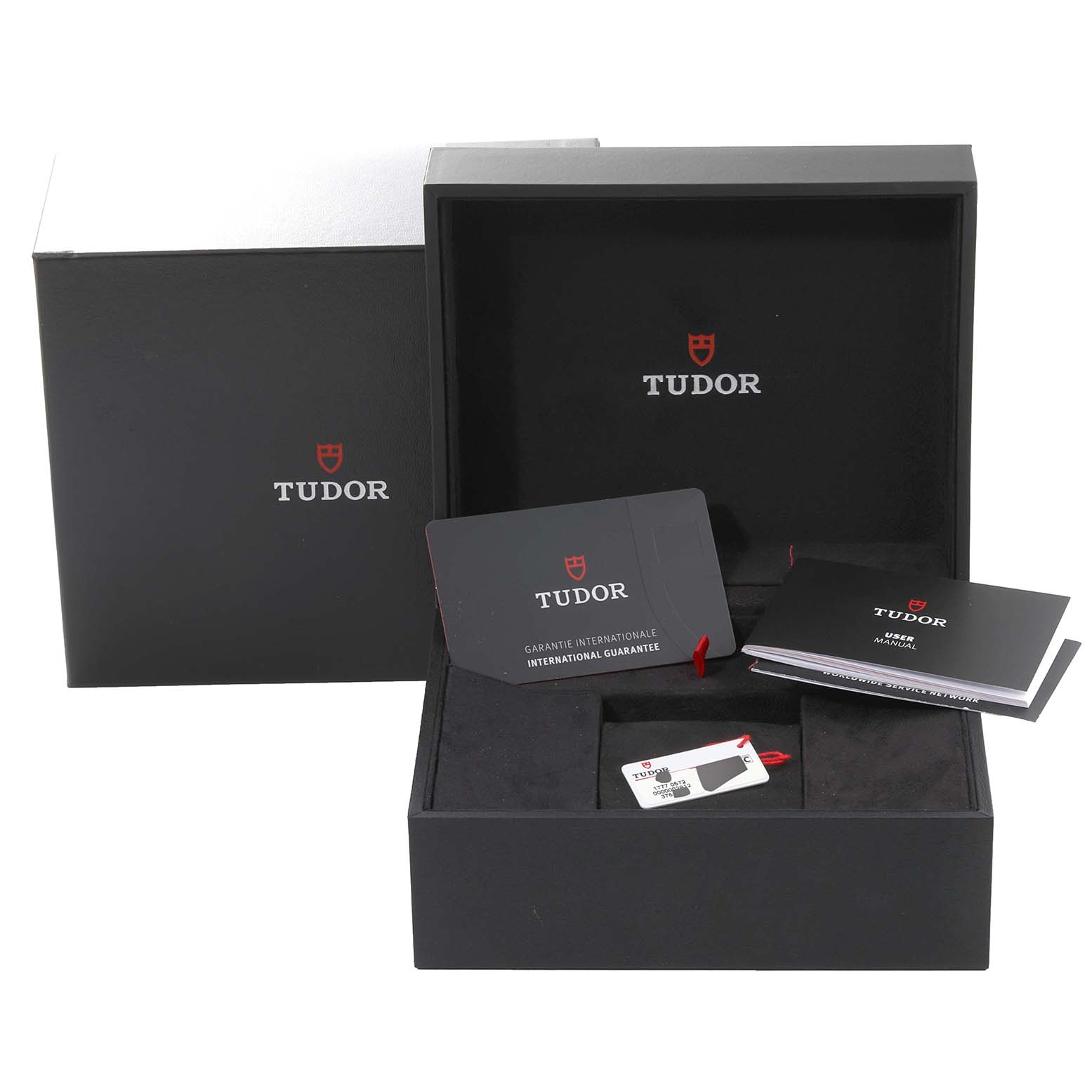 The image shows the Tudor Heritage Black Bay 79830RB Men
s Stainless Steel Black Dial 79830RB Men
s Stainless Steel Black Dial packaging, including the box, warranty card, and user manual.