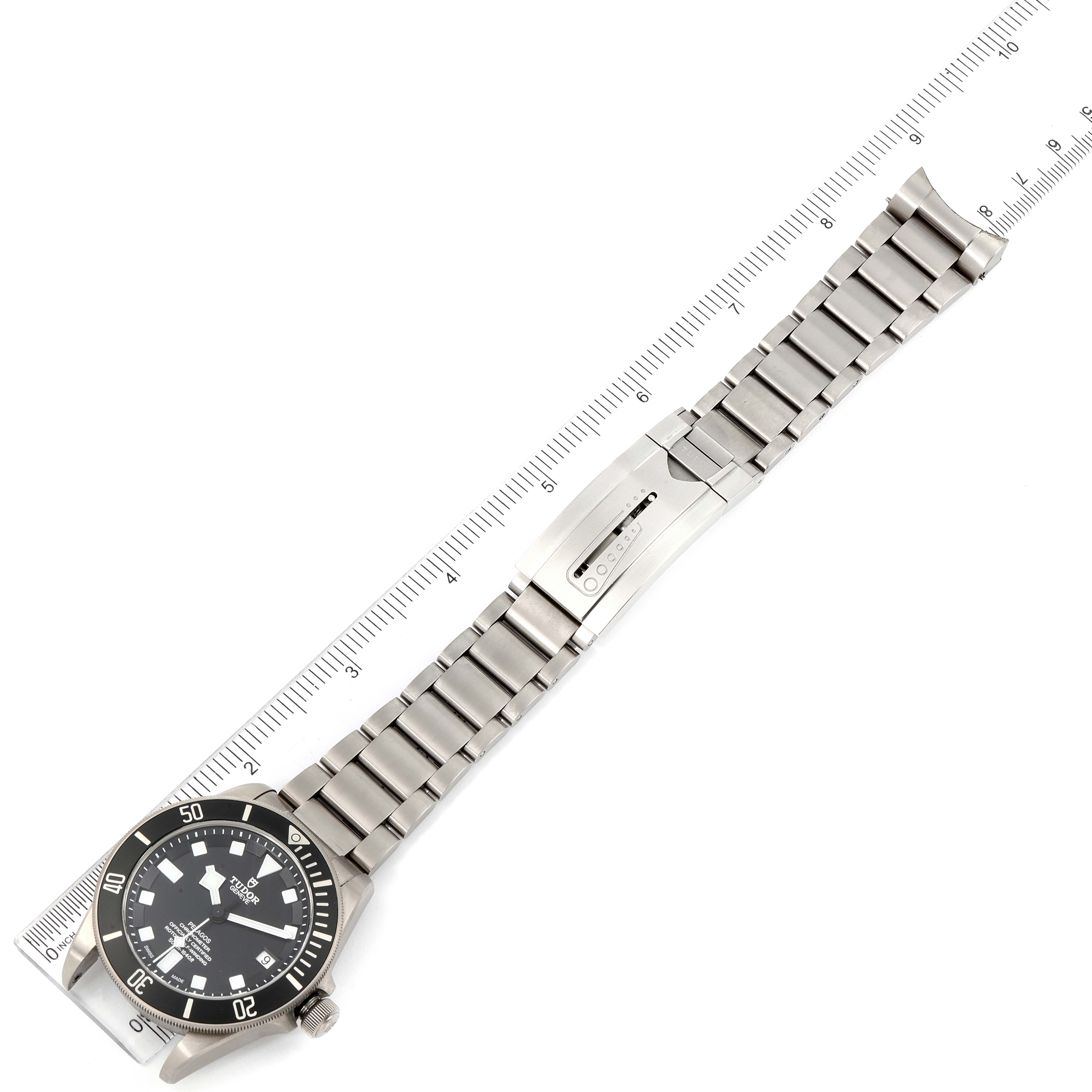 The image shows a top-down view of a Tudor Pelagos 25500TN Men's Titanium Black Dial 25500TN Men's Titanium Black Dial watch, including the dial, bezel, bracelet, and clasp, aligned with a ruler.