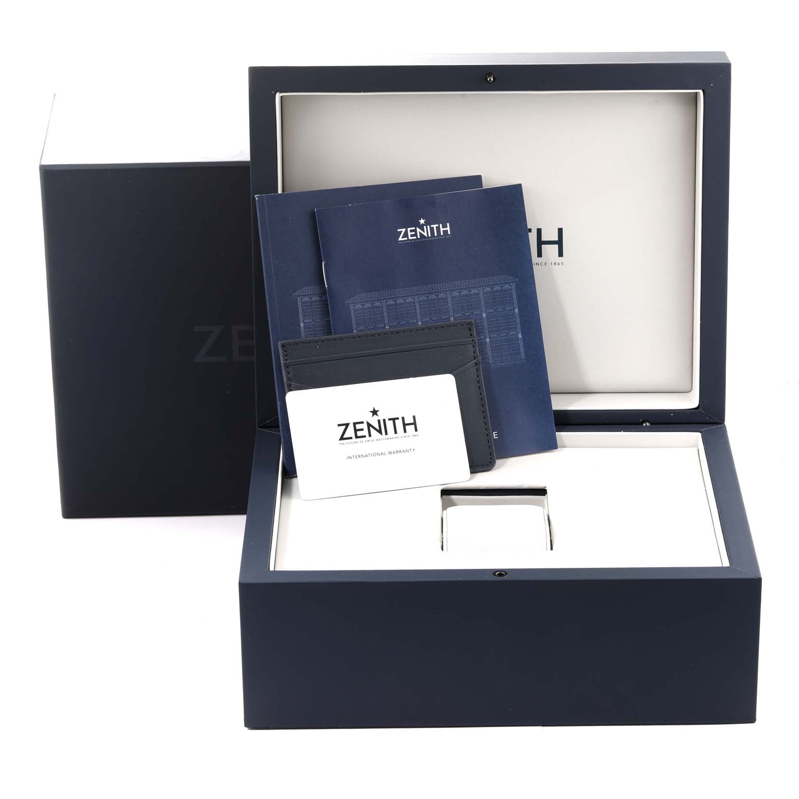 The image shows the packaging and accessories for a Zenith Chronomaster 03.3102.3600/02.M3100 Men's Stainless Steel White Dial 03.3102.3600/02.M3100 Men's Stainless Steel White Dial watch, including manuals and a warranty card.