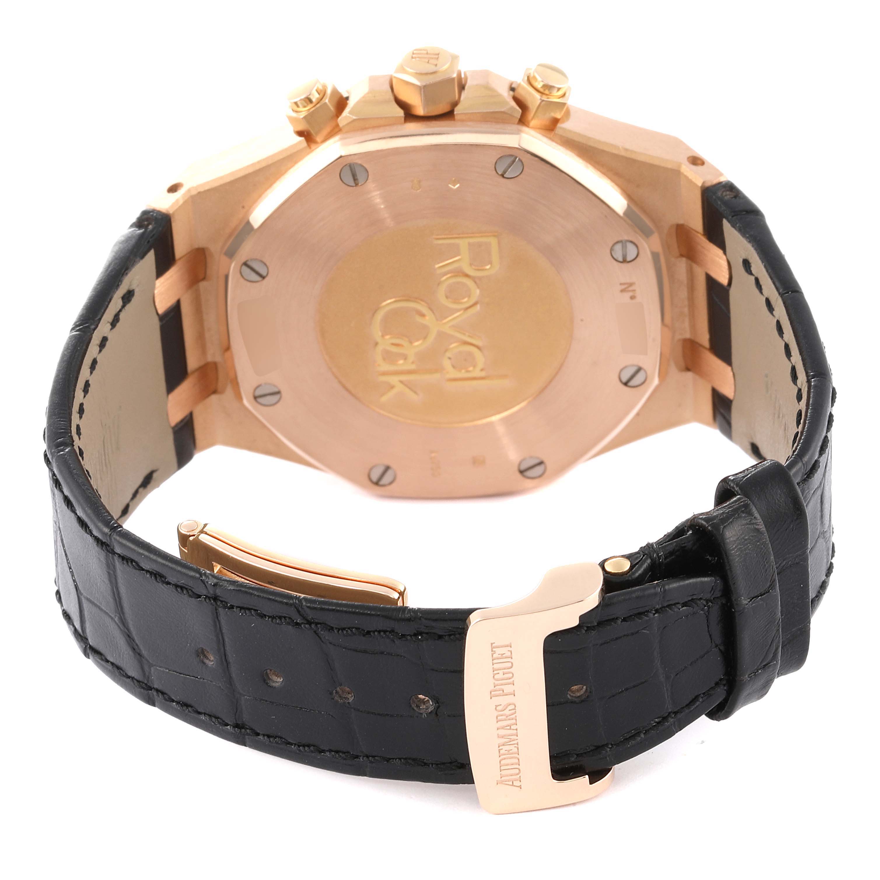 The image shows the back of a Royal Oak model by Audemars Piguet, featuring its caseback and black leather strap with clasp.