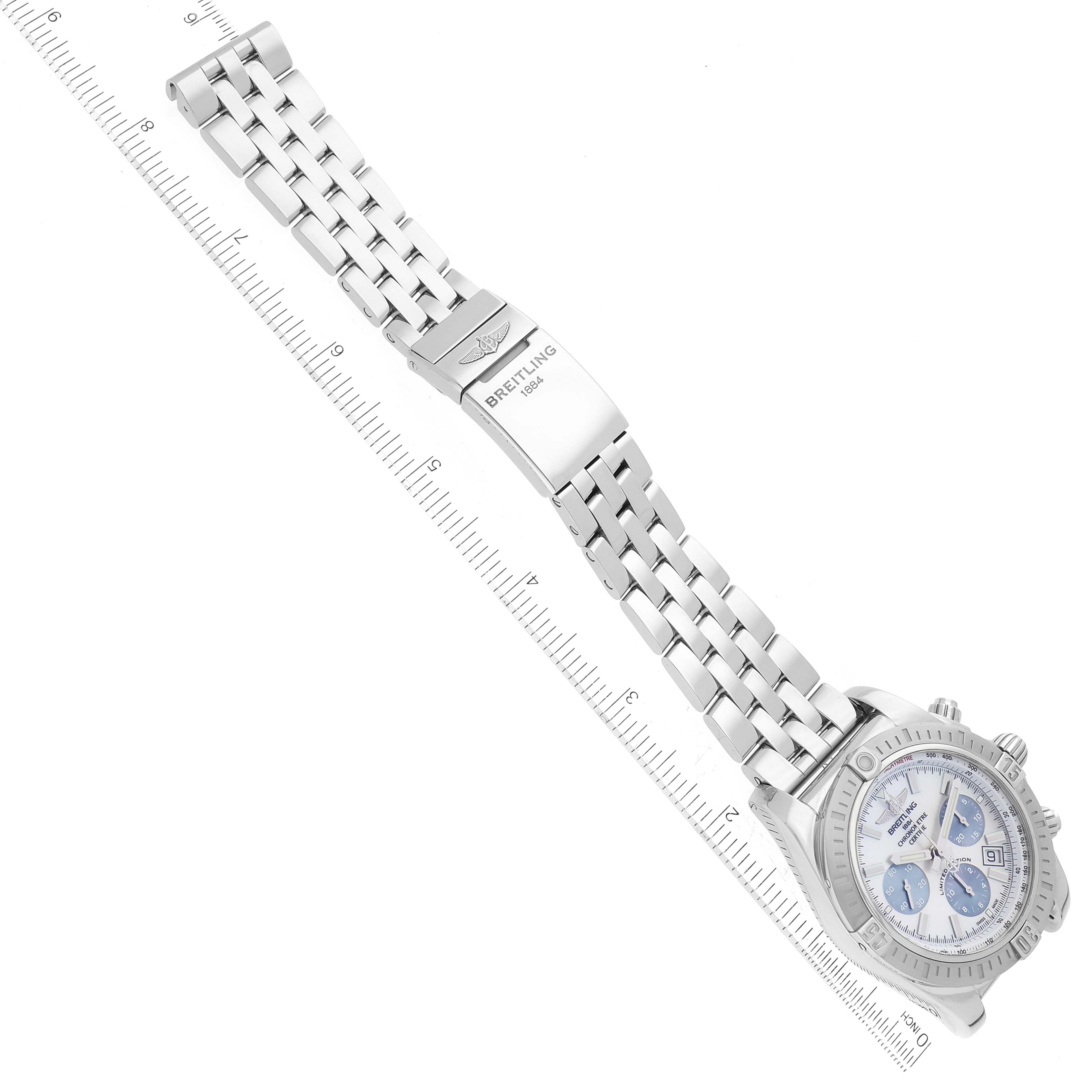 The image shows a Breitling Chronomat AB0115 Men's Stainless Steel Mother of Pearl Dial AB0115 Men's Stainless Steel Mother of Pearl Dial watch displayed at an angle with a visible bracelet and a ruler for scale.