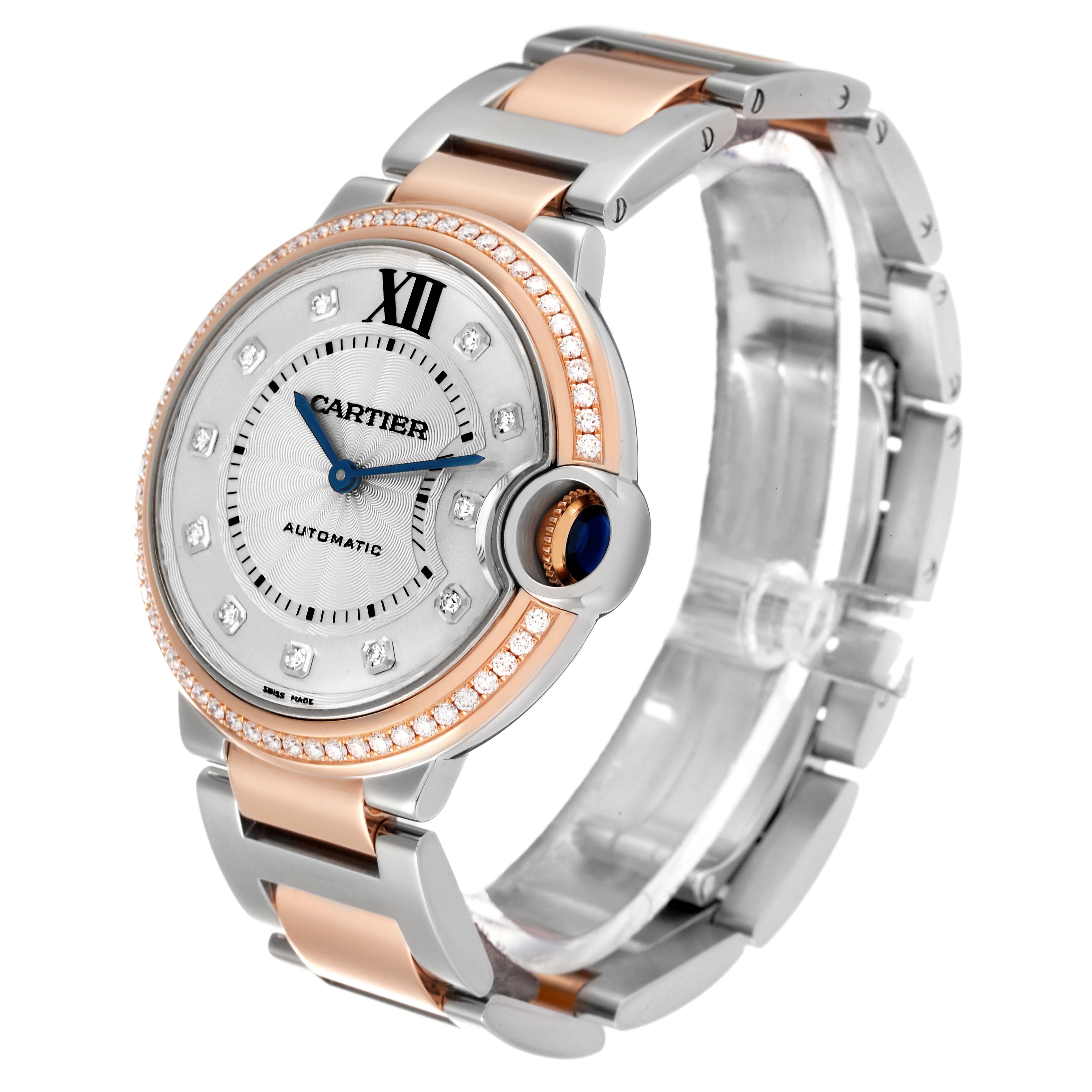 The image shows an angled side view of a Cartier Ballon Bleu W3BB0004 Women
s Steel and Gold (two tone) Silver Dial W3BB0004 Women
s Steel and Gold (two tone) Silver Dial watch displaying its face, crown, bracelet, and diamond-studded bezel.