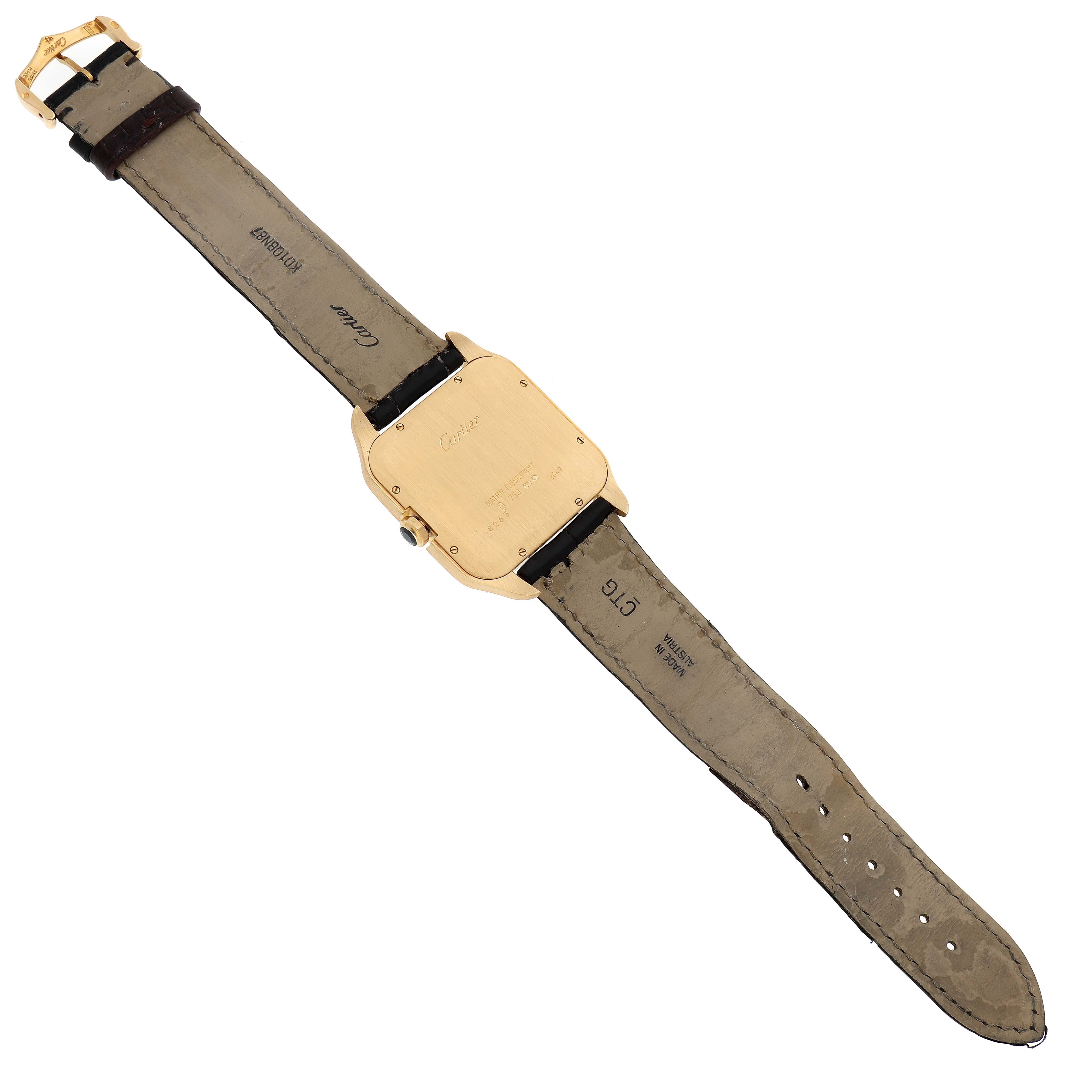 The image shows the back of a Santos Dumont watch by Cartier, displaying the straps and case back.