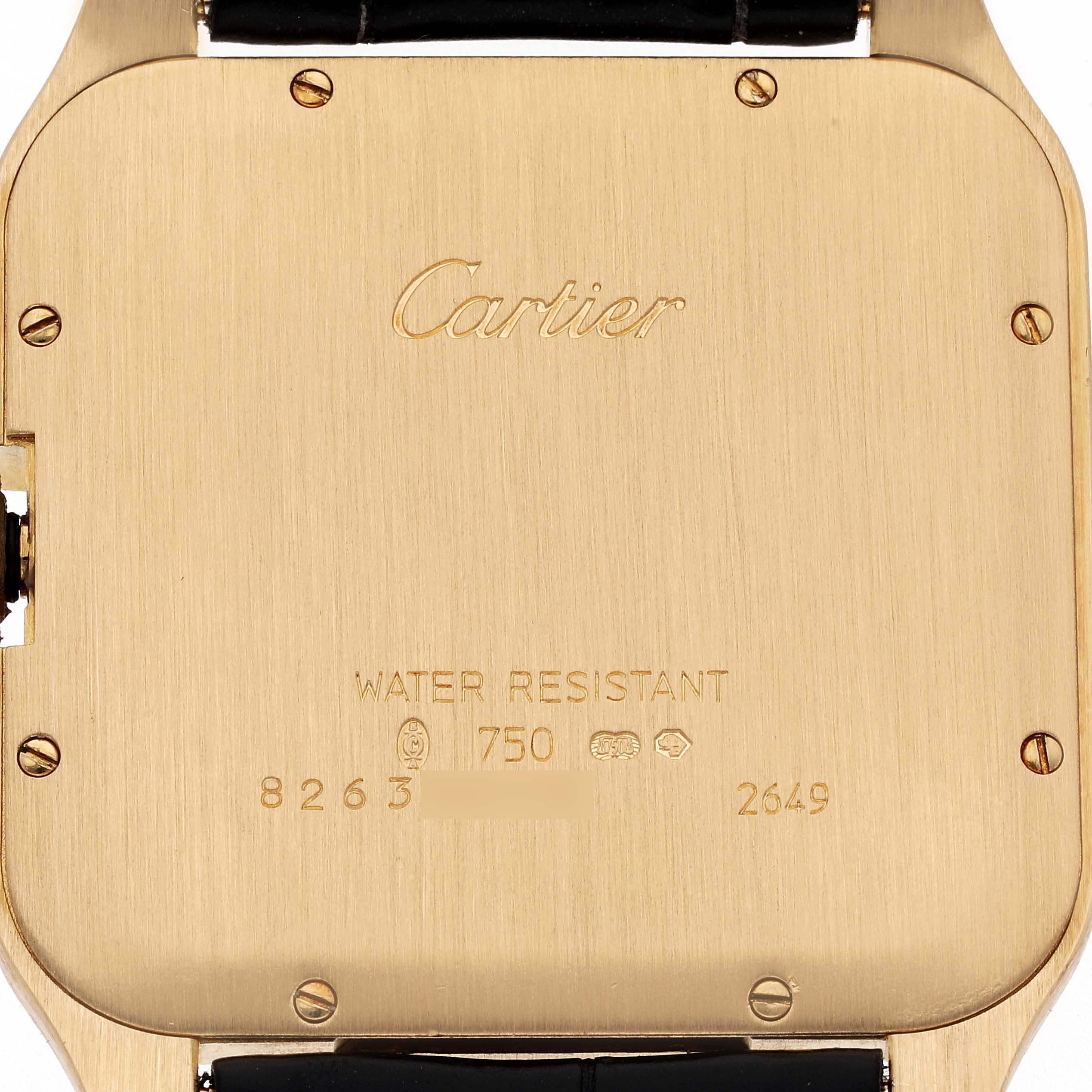 The image shows the backside of a Cartier Santos Dumont W2008751 Men's Yellow Gold Silver Dial W2008751 Men's Yellow Gold Silver Dial watch, highlighting the brand's engraving and screw details.