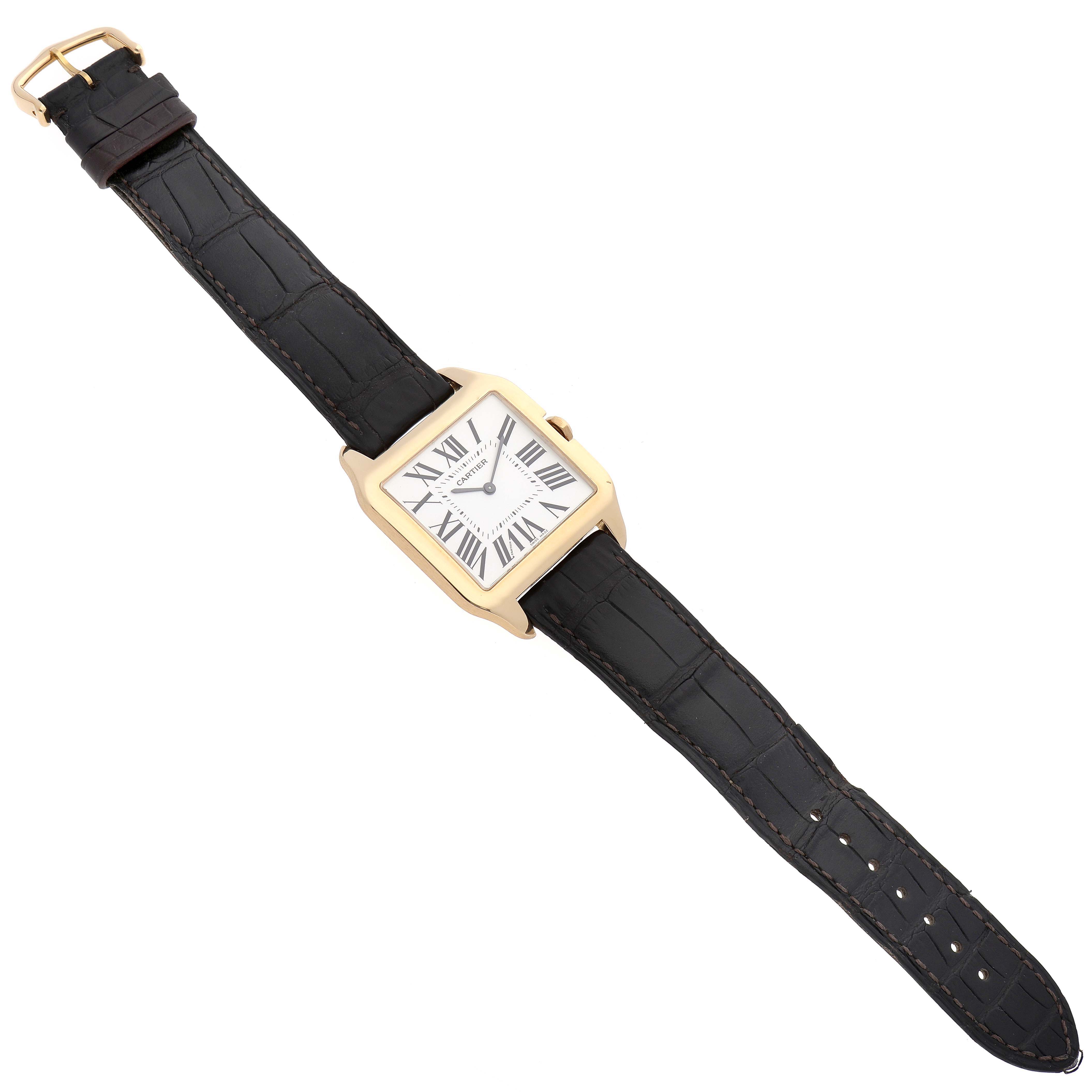 The Cartier Santos Dumont W2008751 Men's Yellow Gold Silver Dial W2008751 Men's Yellow Gold Silver Dial watch is shown from a top view, detailing the face, strap, and buckle.