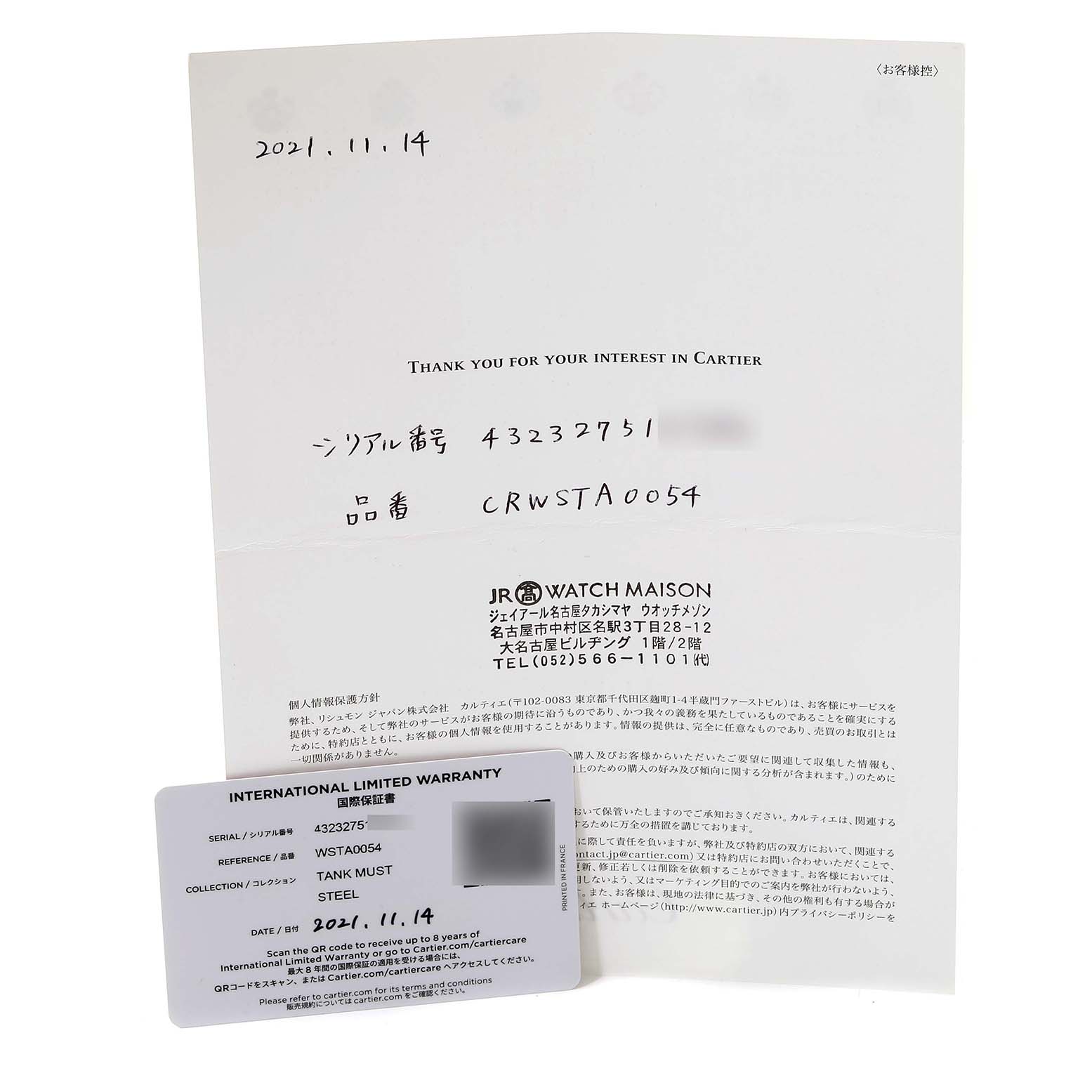 The image shows an International Limited Warranty card and a document for a Tank Must model by Cartier, viewed from above.