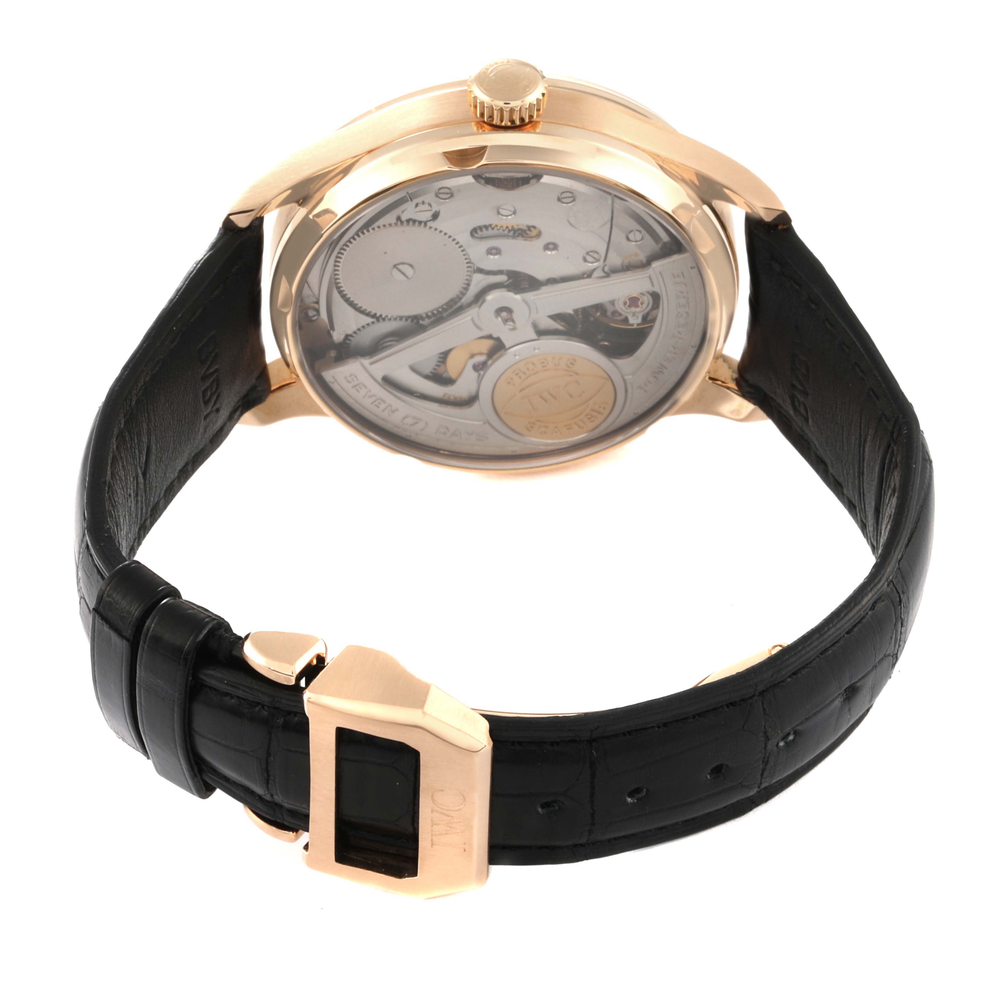 The image shows the rear view of the IWC Portuguese IW500701 Men's Rose Gold Silver Dial IW500701 Men's Rose Gold Silver Dial model watch, highlighting its movement and black leather strap.