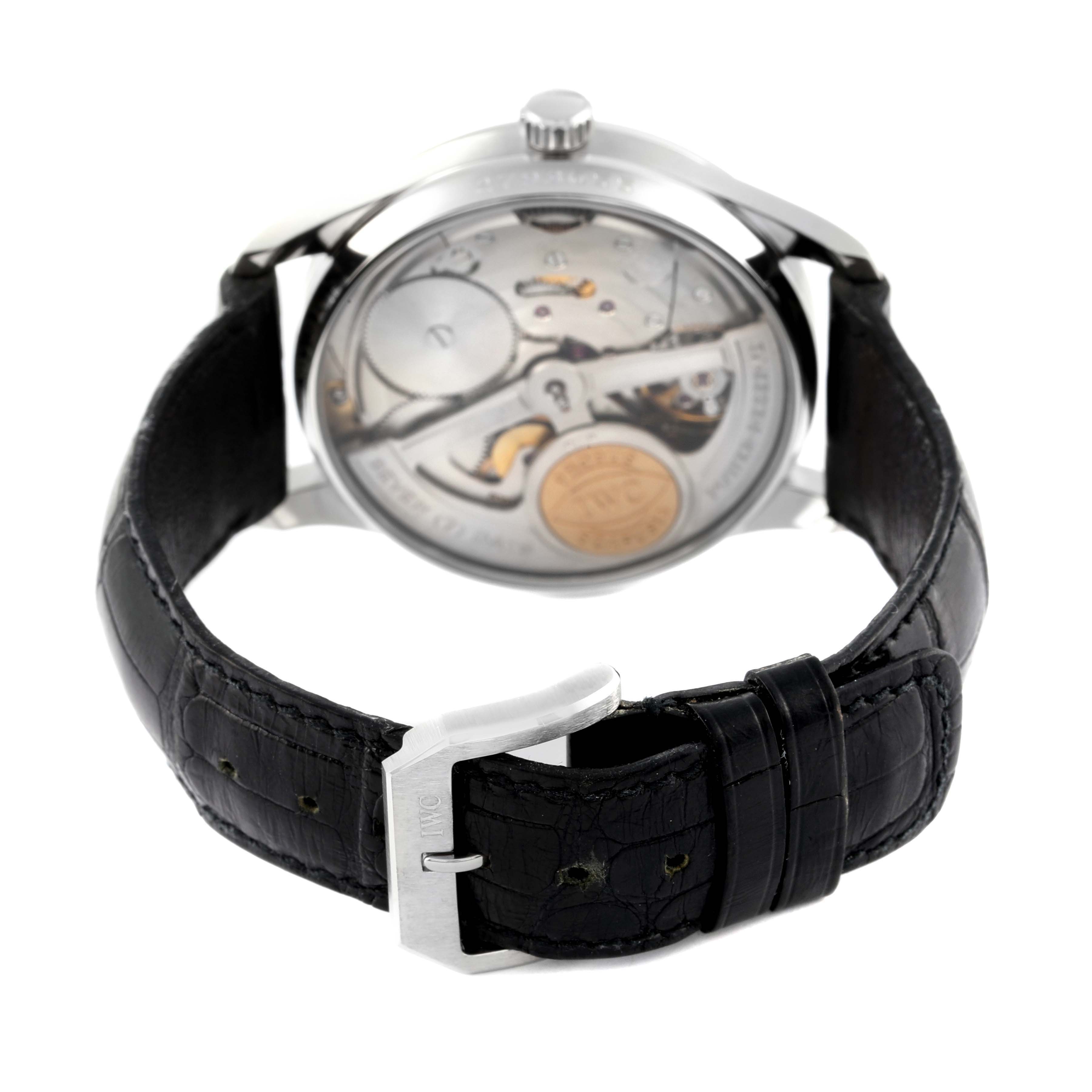 The image shows the back view of an IWC Portuguese IW500001 Men's Stainless Steel Black Dial IW500001 Men's Stainless Steel Black Dial model watch, featuring the watch's movement and black leather strap.