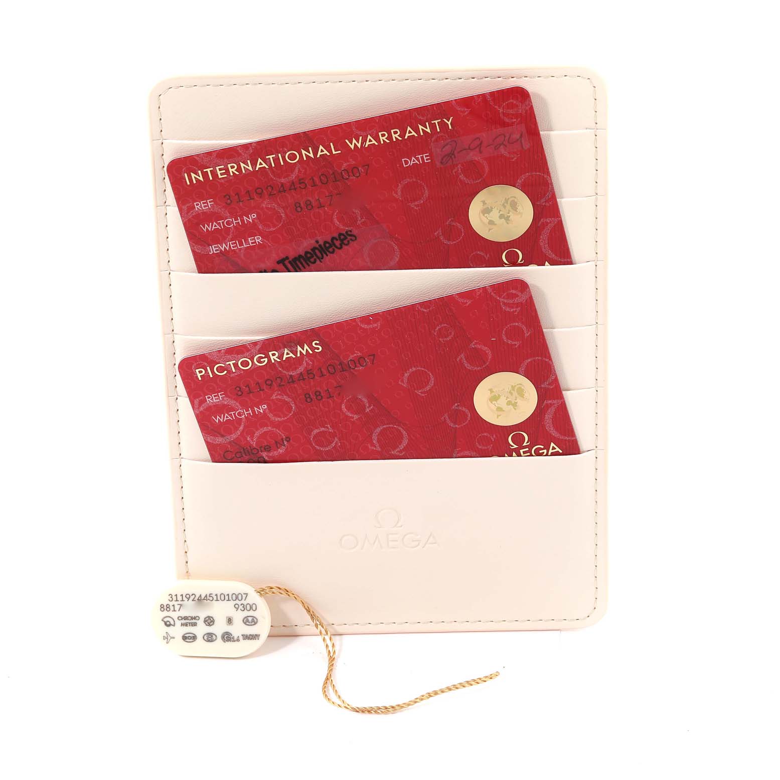 The image shows the warranty and pictogram cards along with a tag for the Omega Speedmaster 311.92.44.51.01.007 Men's Ceramic Black Dial 311.92.44.51.01.007 Men's Ceramic Black Dial watch.