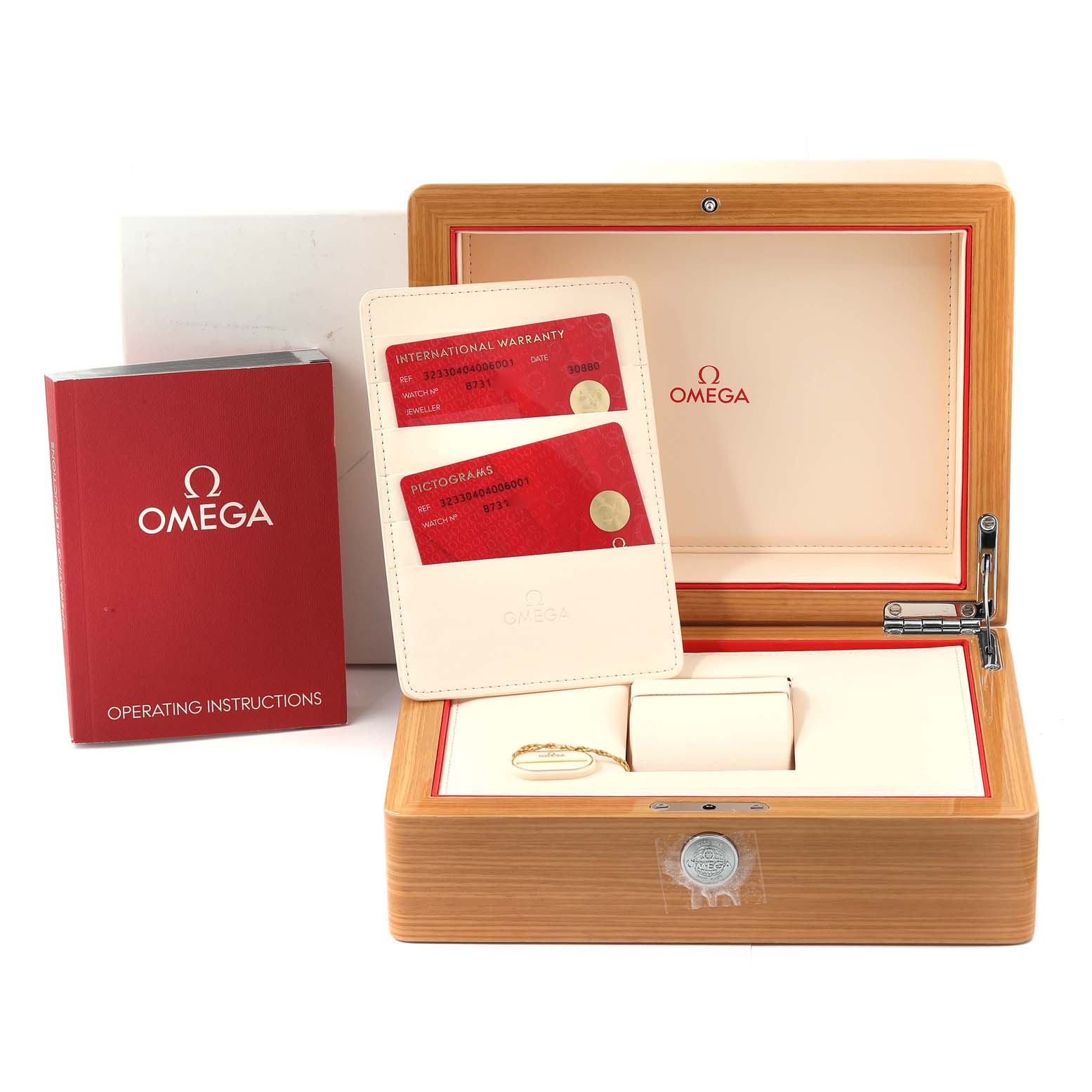 The image shows a wooden Omega Speedmaster 323.30.40.40.06.001 Men
s Stainless Steel Grey Dial 323.30.40.40.06.001 Men
s Stainless Steel Grey Dial watch box, warranty cards, and an operating instructions booklet.