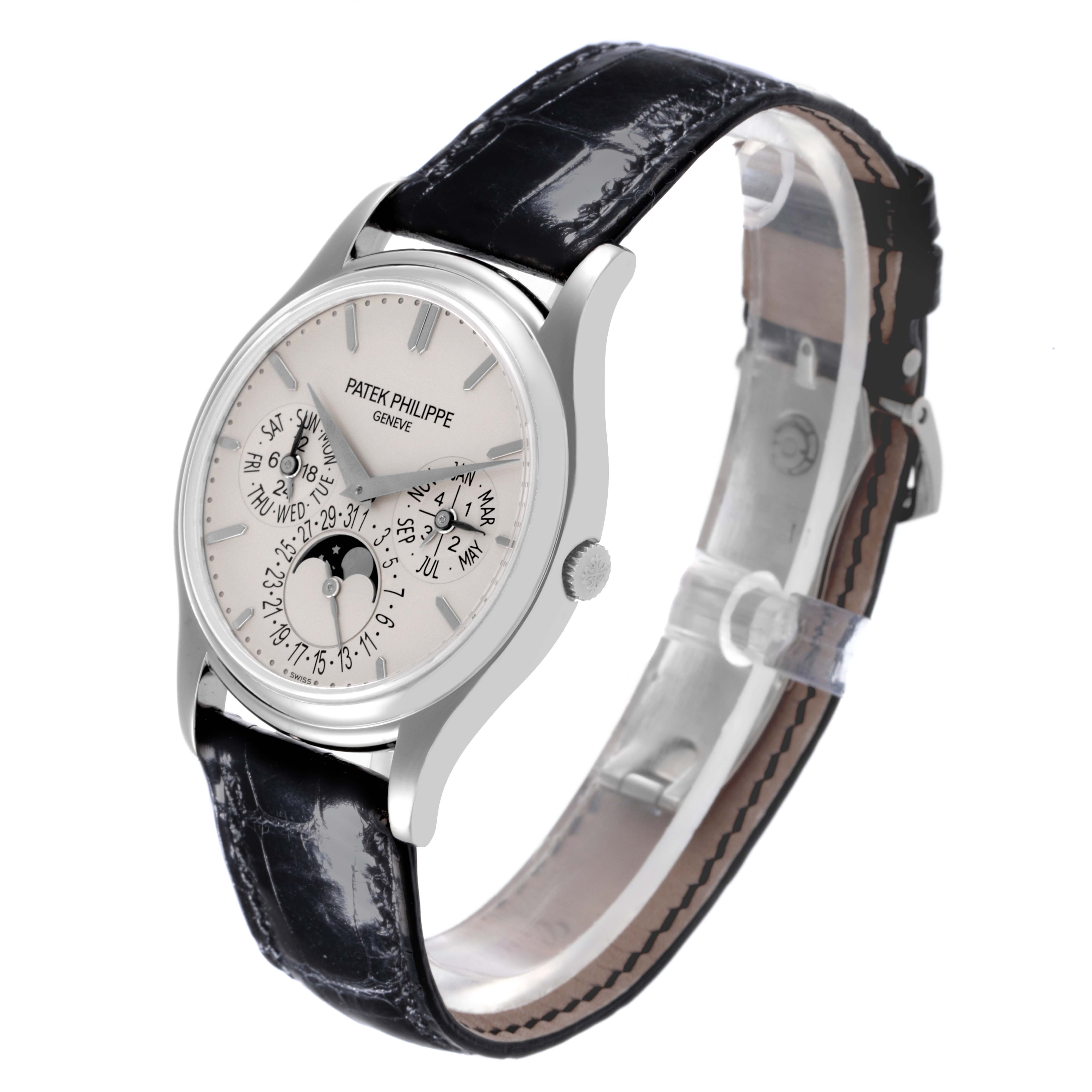 The Patek Philippe Calatrava 5140G-001 Men's White Gold Silver Dial 5140G-001 Men's White Gold Silver Dial watch is shown at a slight side angle, displaying its face, leather strap, and clasp.