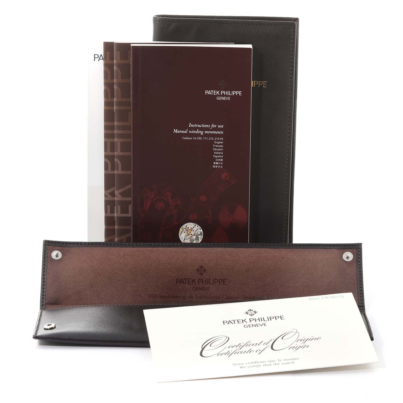 This image shows the instruction manuals, certificate of origin, and a leather pouch for the Patek Philippe Gondolo 5098R Men
s Rose Gold Silver Dial 5098R Men
s Rose Gold Silver Dial watch.