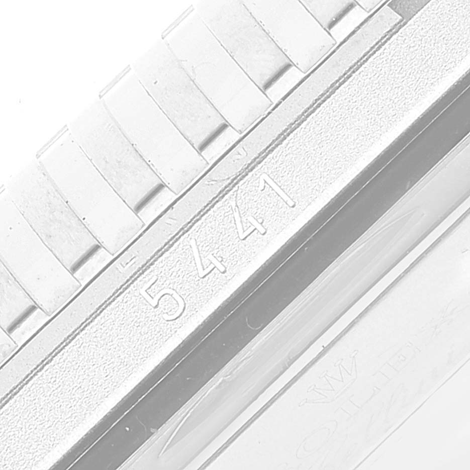 This close-up image shows the serial number and part of the bracelet of the Rolex Cellini 5441/9 Men
s White Gold Silver Dial 5441/9 Men
s White Gold Silver Dial watch.