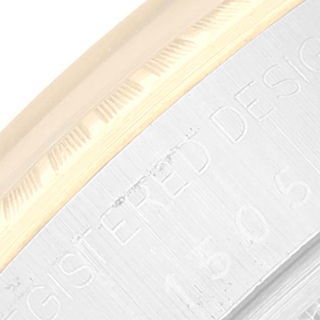 The image shows a close-up of the outer bezel and engraved text on the case back of a Vintage Collection Rolex watch.