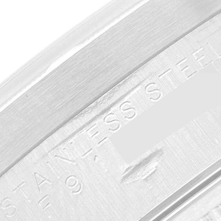 This close-up image shows the "STAINLESS STEEL" engraving on the case of a Rolex Date 15210 Men's Stainless Steel White Dial 15210 Men's Stainless Steel White Dial model watch.