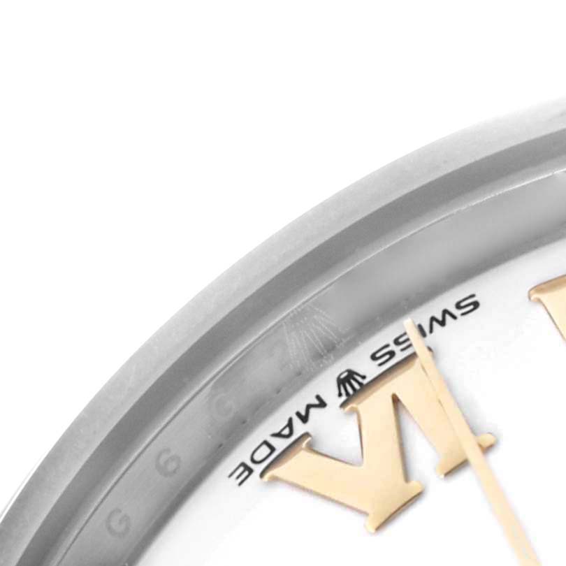 The image shows a close-up of the bezel and part of the dial of a Rolex Mid-Size 278243 Women's Steel and Gold (two tone) White Dial 278243 Women's Steel and Gold (two tone) White Dial watch, highlighting the "Swiss Made" text and a portion of a numeral.